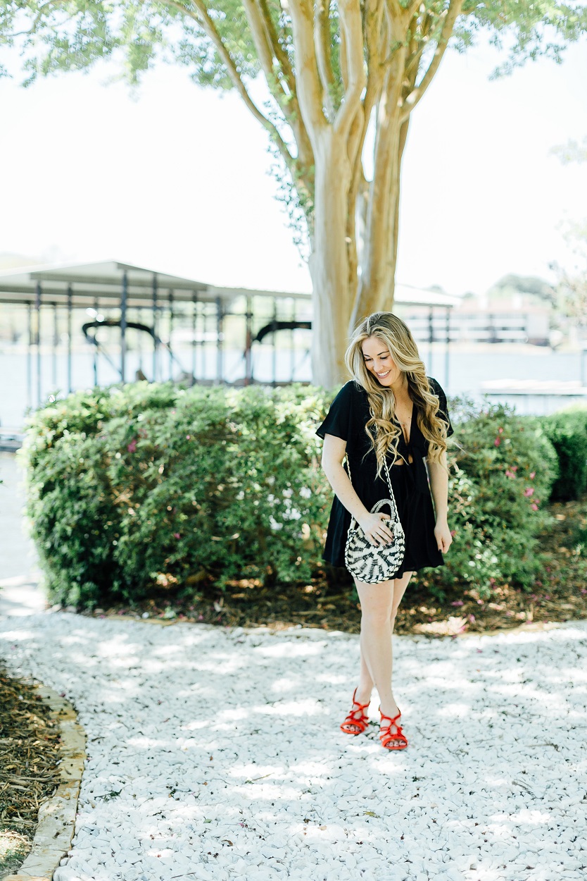 Tie black romper styled by popular fashion blogger, Walking in Memphis in High Heels