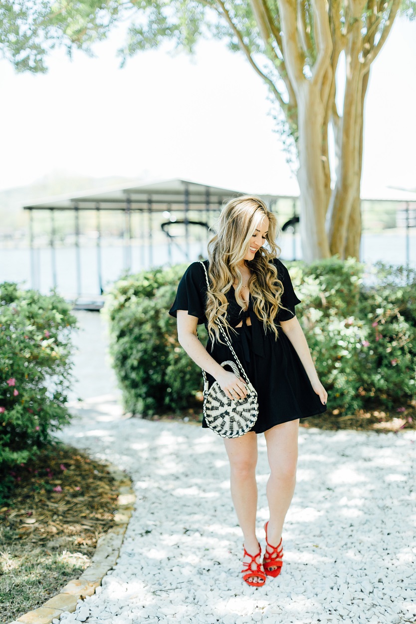 Tie black romper styled by popular fashion blogger, Walking in Memphis in High Heels