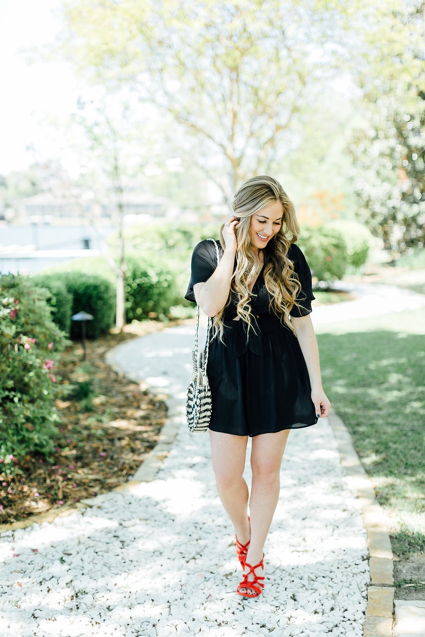 Tie black romper styled by popular fashion blogger, Walking in Memphis in High Heels