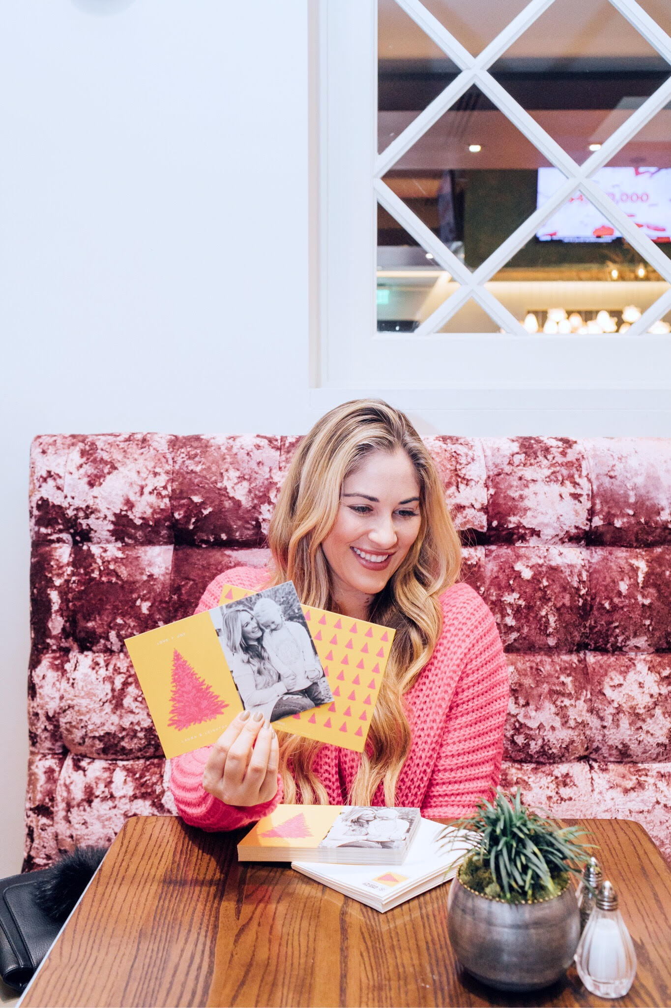 Minted Giveaway for your next Holiday Cards, featured by top lifestyle blog, Walking in Memphis in High Heels: blonde woman sitting smiling and holding her Minted Holiday cards