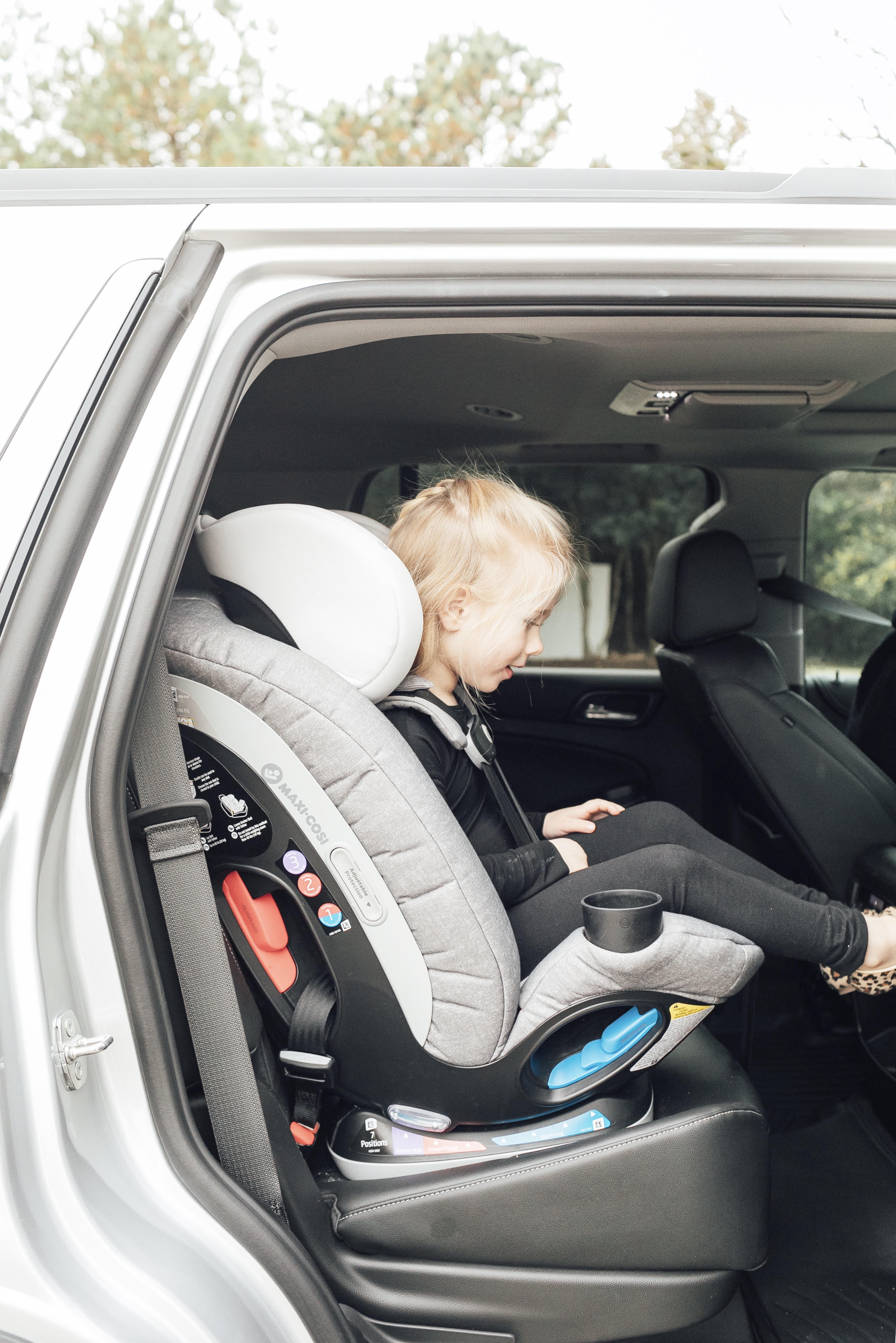 Top US lifestyle blog, Walking in Memphis in High Heels, features some Fun Ideas for Long Road Trips to entertain your children: image of a toddler in her Maxi Cosi car seat