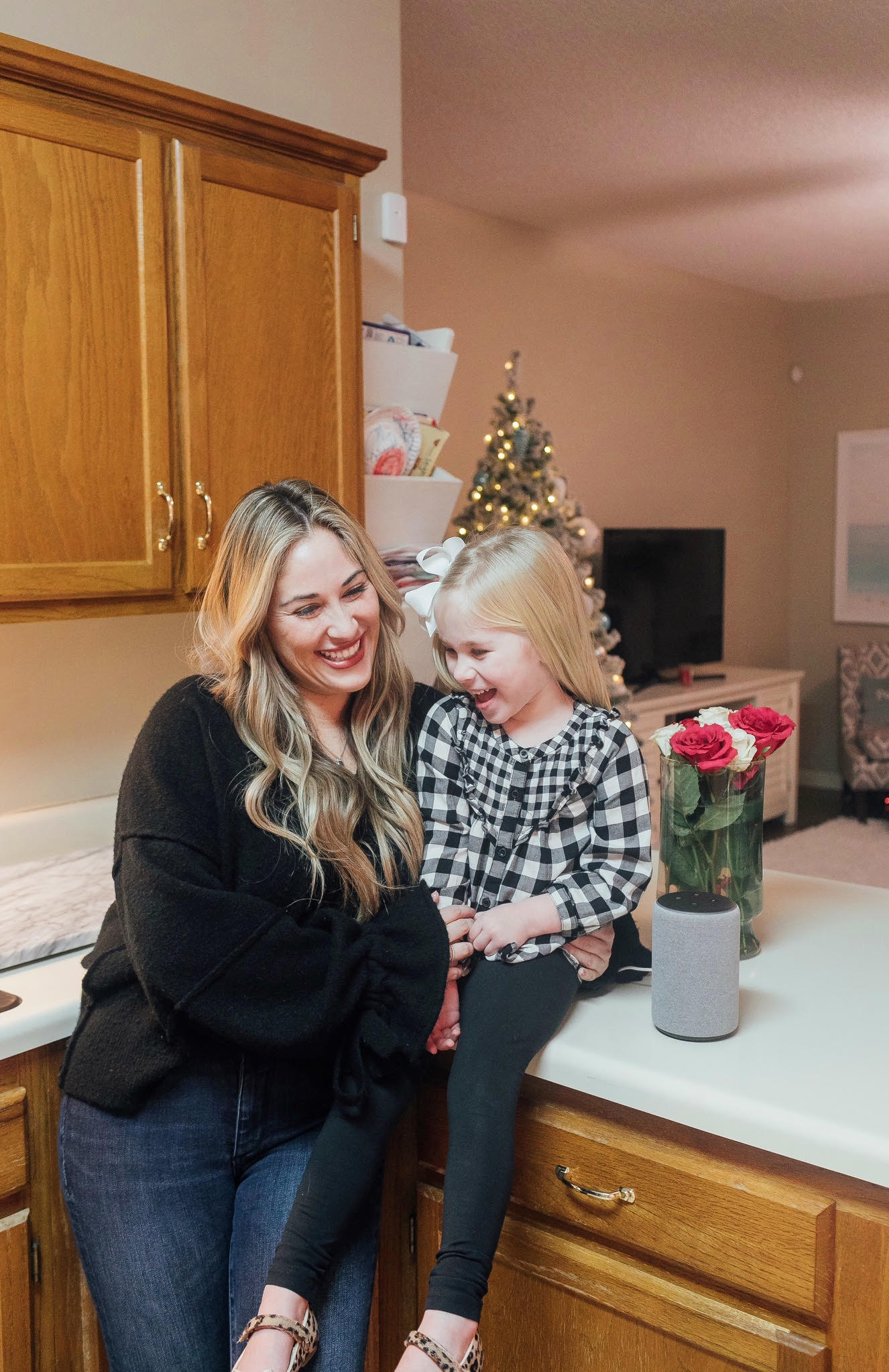 The New Amazon Echo Dot Kids review featured by top US lifestyle blog, Walking in Memphis in High Heels: image of a woman and daughter having fun using the new Amazon Echo Dot Kids.