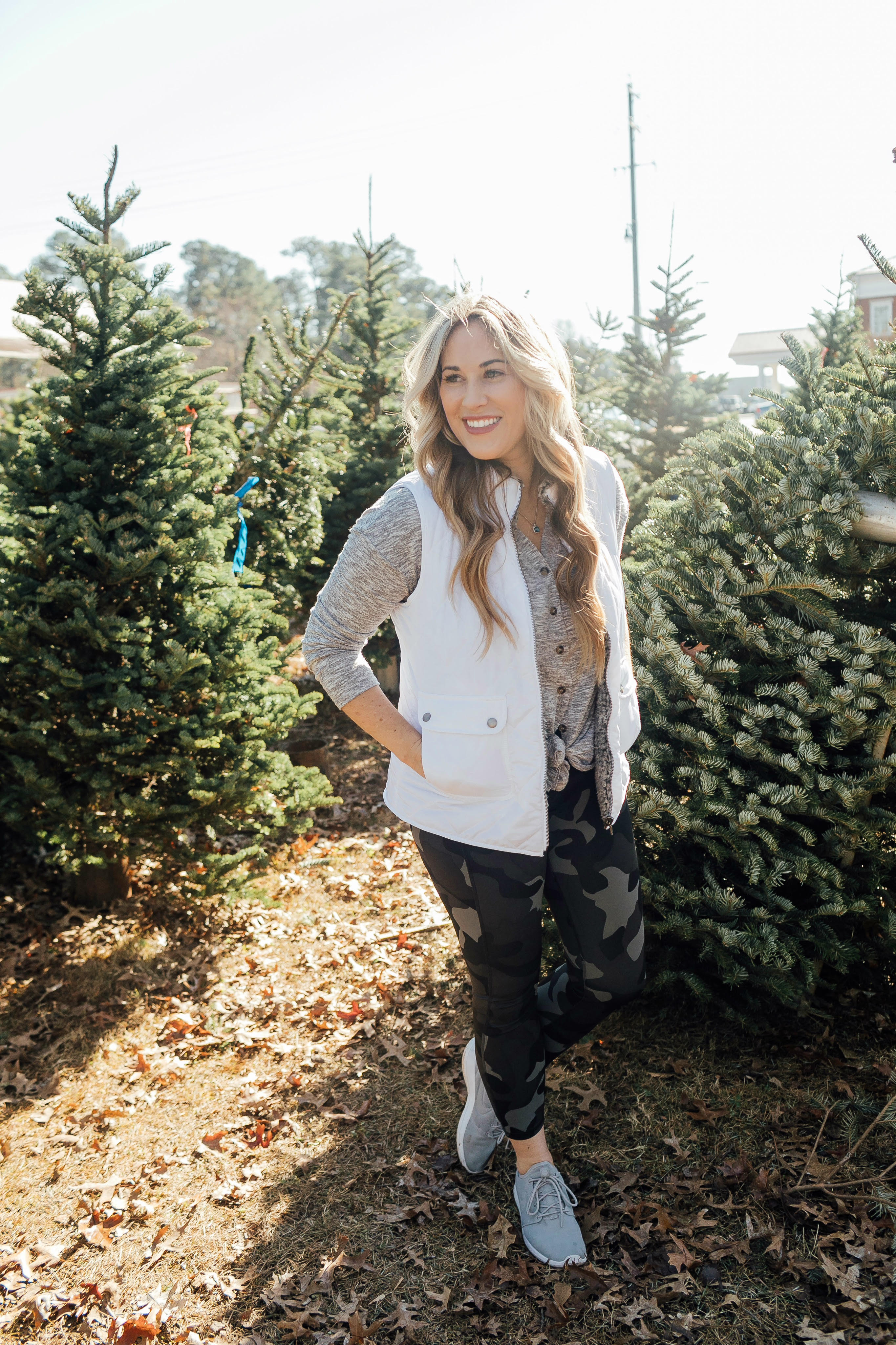 Full Abs Workout featured by top US fitness blog, Walking in Memphis in High Heels, as part of their Holiday Honey Hustle Challenge: image of a woman working out at a Christmas tree farm
