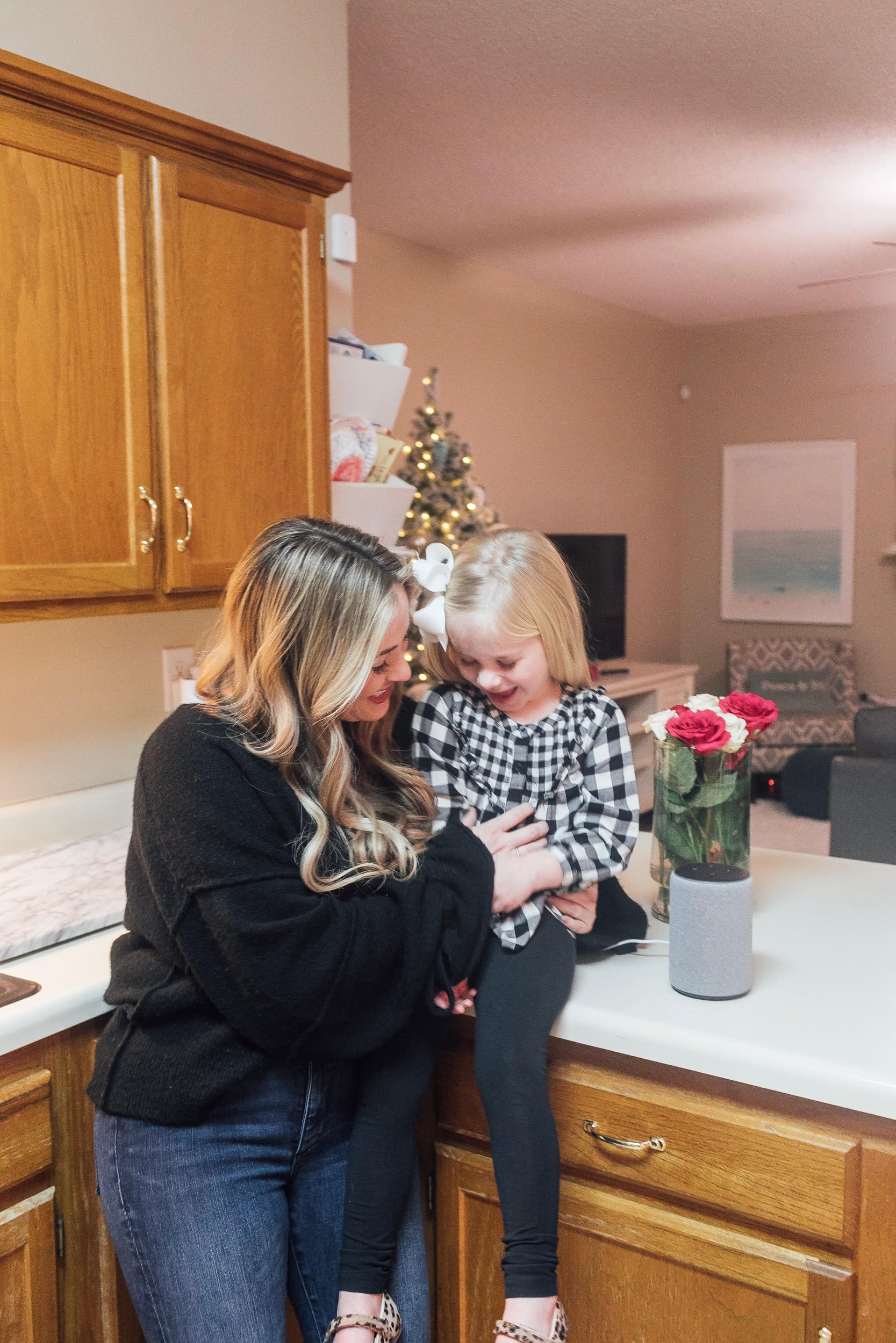 The New Amazon Echo Dot Kids review featured by top US lifestyle blog, Walking in Memphis in High Heels: image of a woman and daughter having fun using the new Amazon Echo Dot Kids.