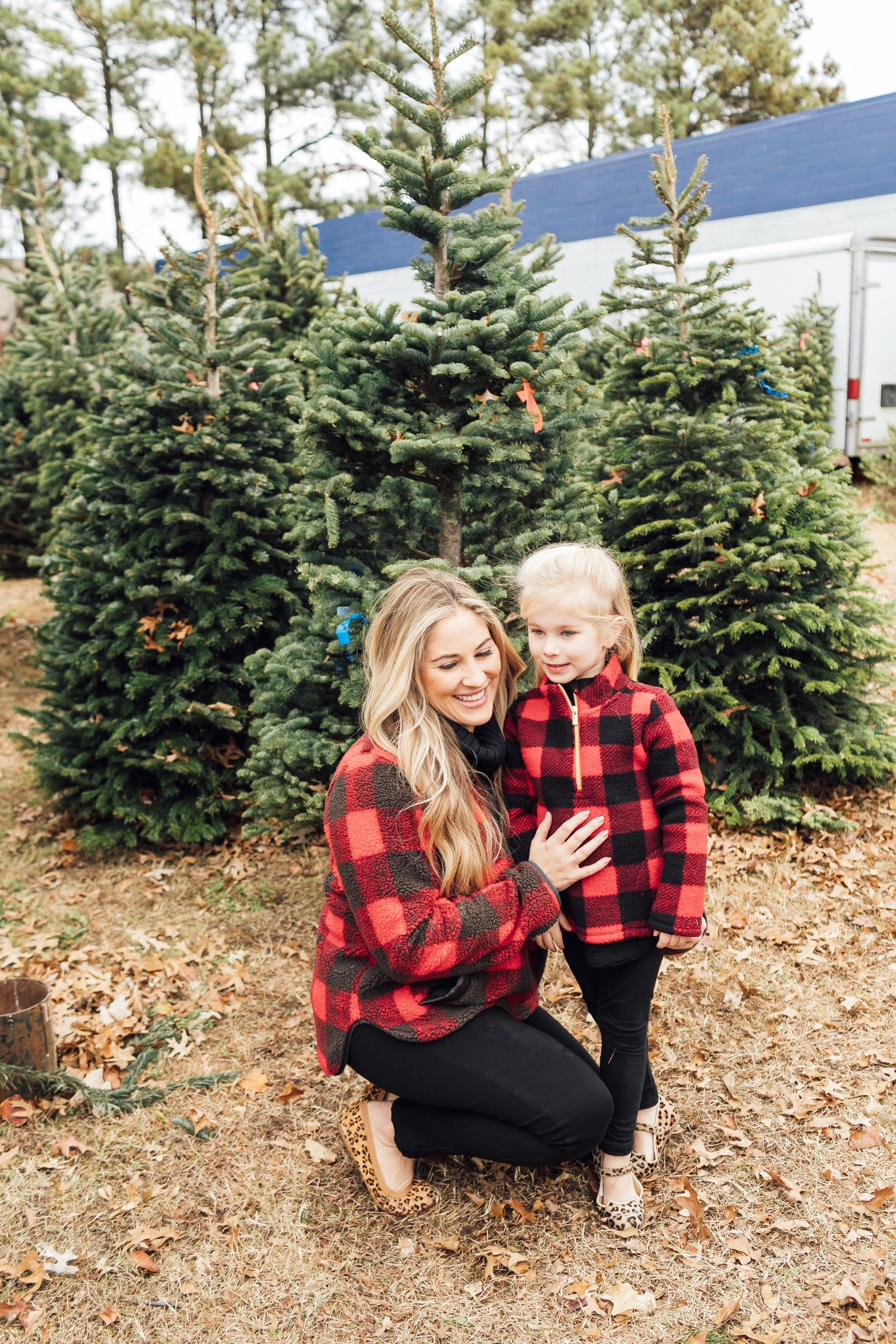 Merry Christmas Wishes featured by top US lifestyle blog, Walking in Memphis in High Heels: image of a mom and daughter wearing red plaid jackets, black jeans and gold shoes