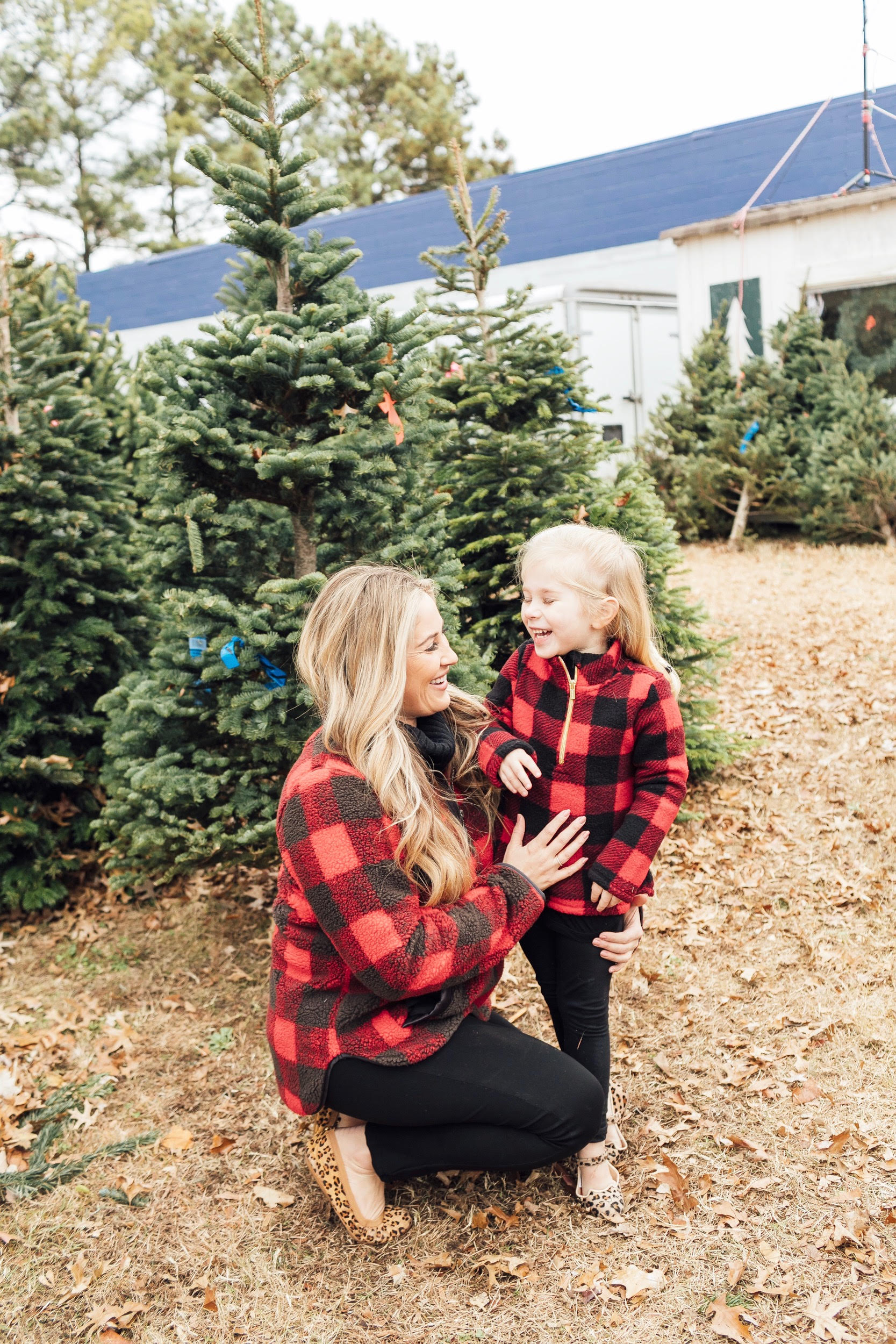 Merry Christmas Wishes featured by top US lifestyle blog, Walking in Memphis in High Heels: image of a mom and daughter wearing red plaid jackets, black jeans and gold shoes