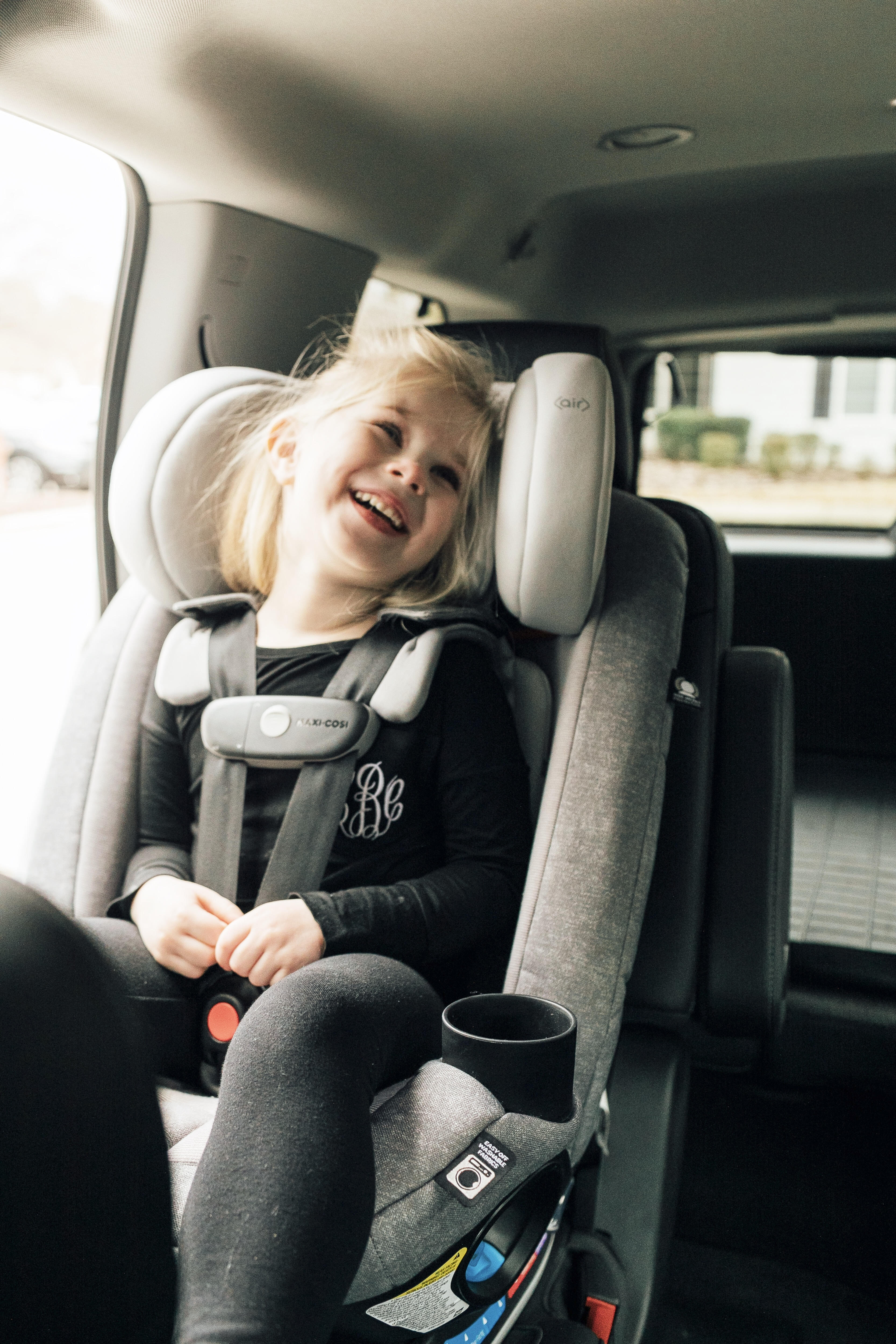 Top US lifestyle blog, Walking in Memphis in High Heels, features some Fun Ideas for Long Road Trips to entertain your children: image of a toddler in her Maxi Cosi car seat