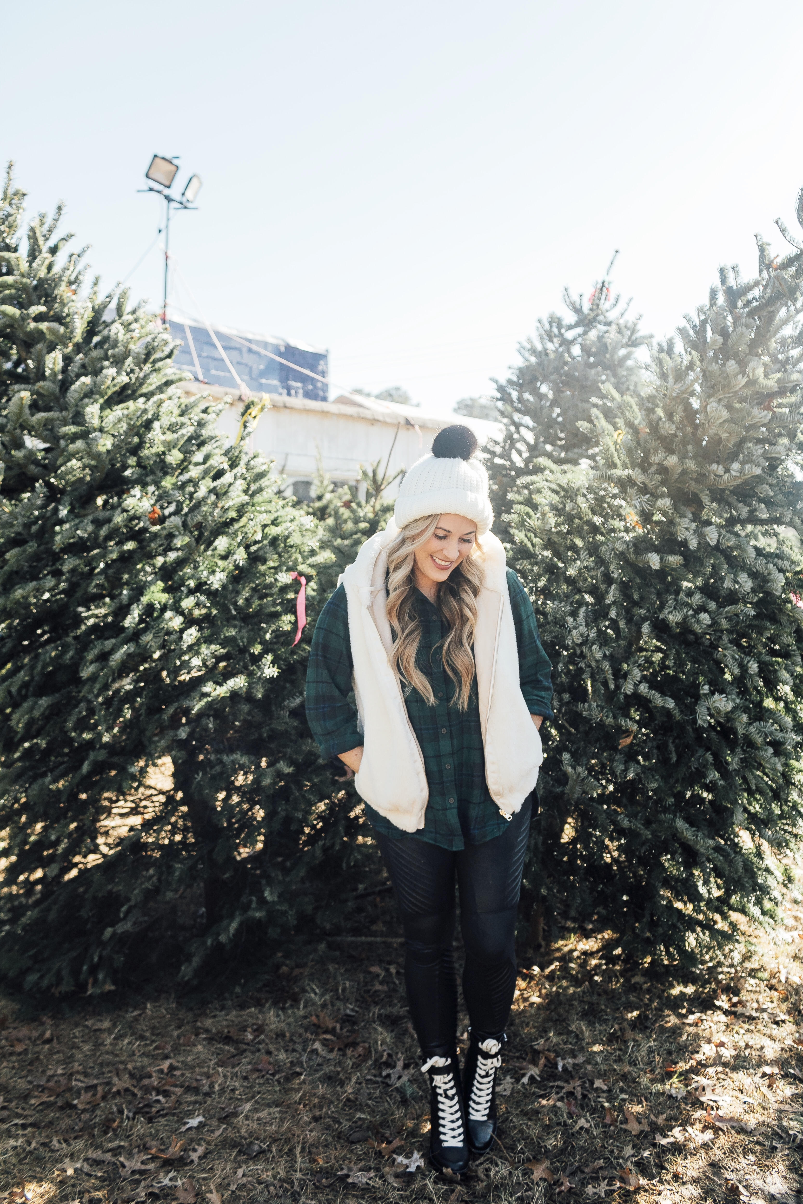 How to style SPANX faux leather leggings featured by top US fashion blog, Walking in Memphis in High Heels: image of a woman wearing SPANX faux leather leggings, Old Navy plaid shirt, faux shearling hooded vest, Marc Fisher ankle boots and ASOS pom pom beanie