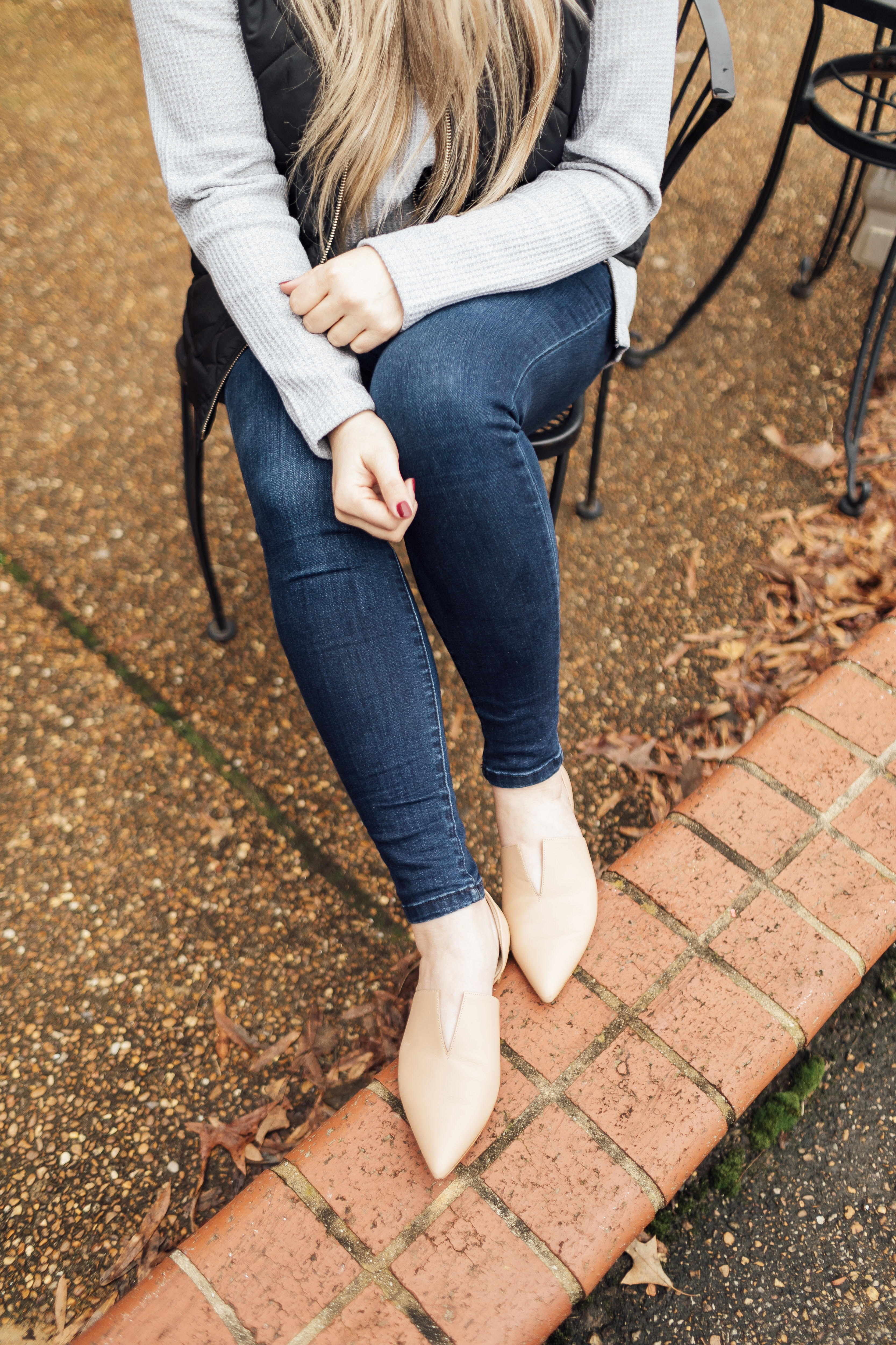 Must have LL Bean thermal top featured by top US fashion blog, Walking in Memphis in High Heels: image of a woman wearing an LL Bean MockNeck Thermal top, Lauren James vest, Joe’s Jeans skinny ankle jeans and Vince Camuto flats.