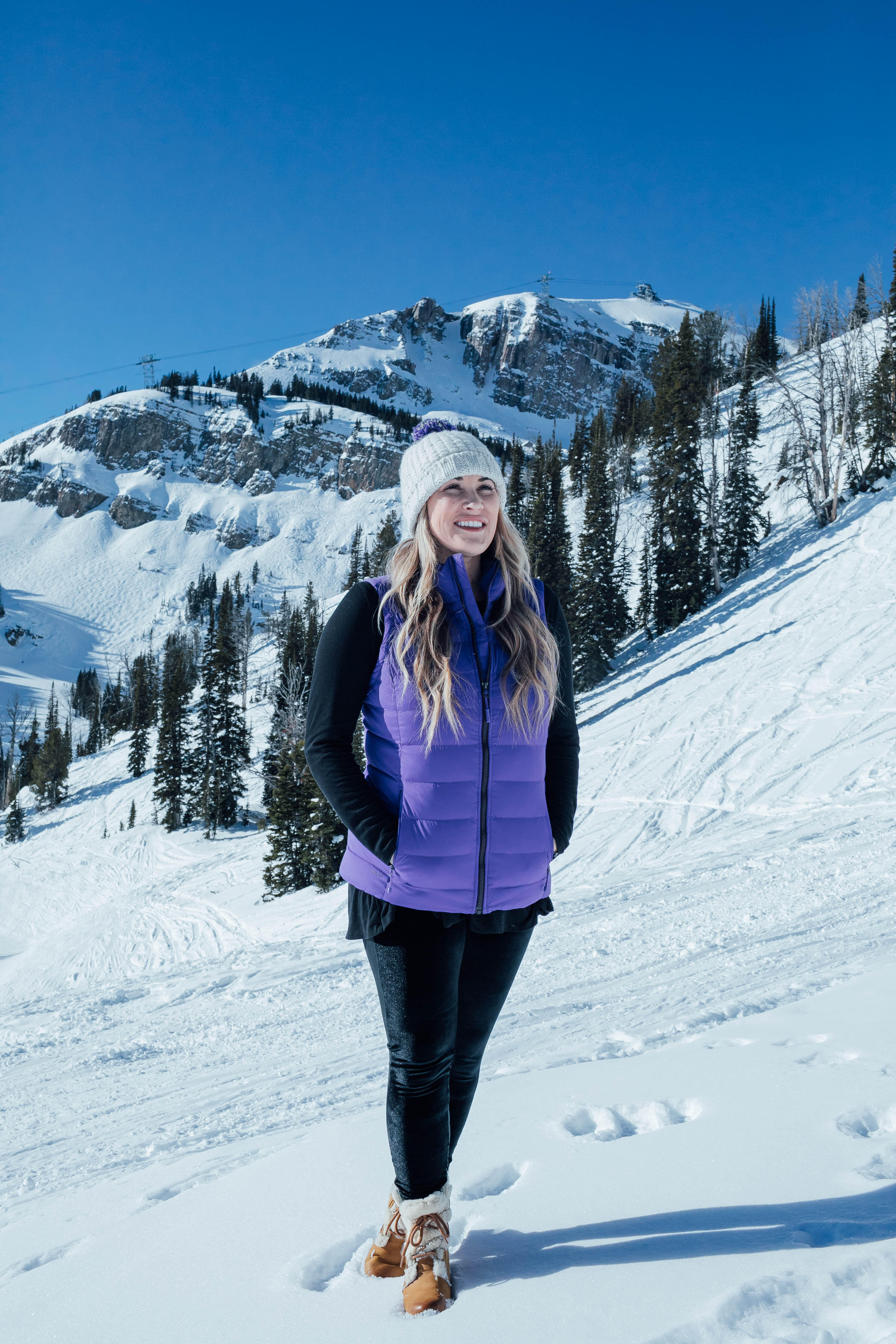 Yummie leggings featured by top US fashion blog, Walking in Memphis in High Heels: image of a woman at a mountain resort wearing Yummie shaping leggings, BP pocket tee, The North Face vest, The North Face pompom beanie hat and Sorel wedge boots