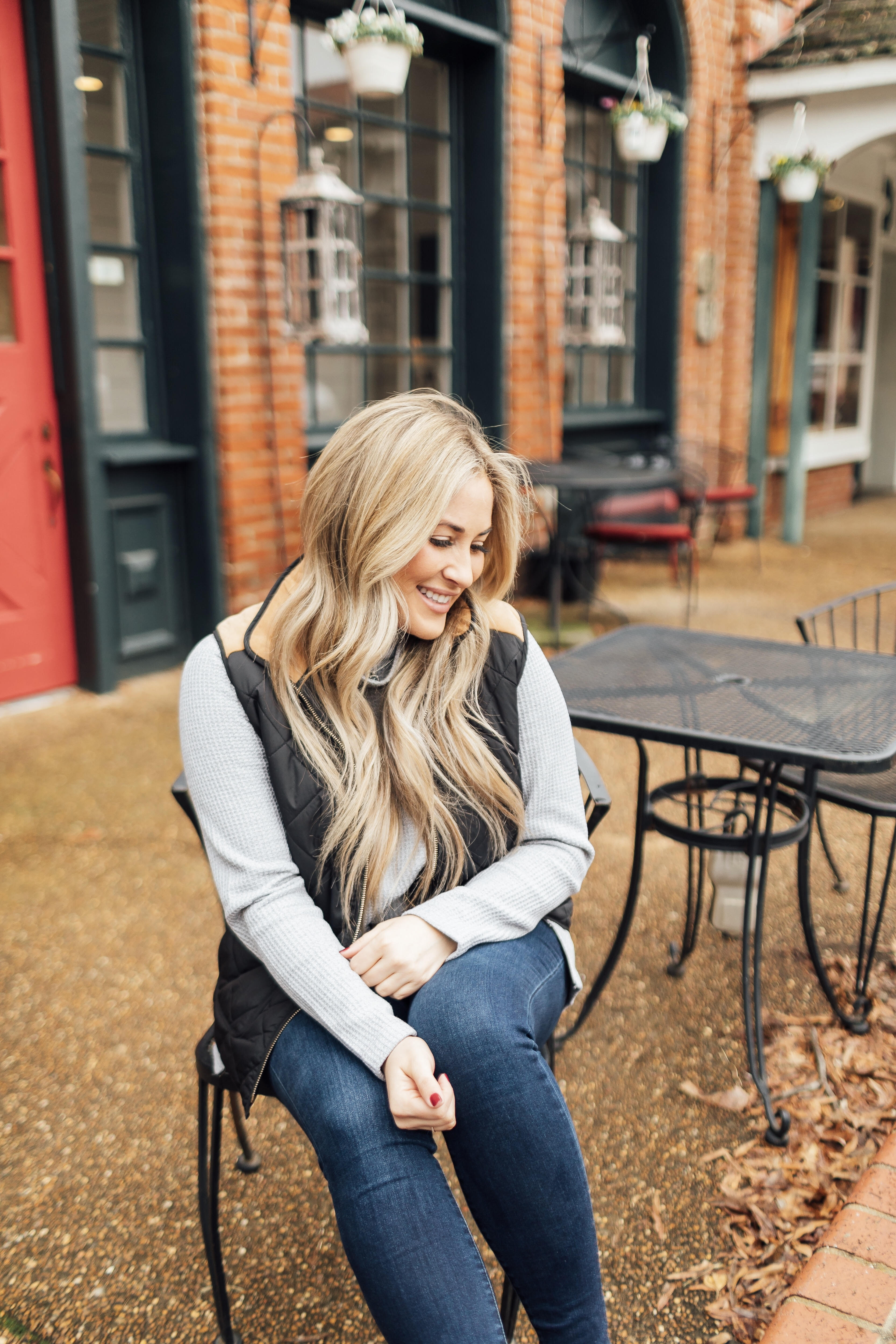 Must have LL Bean thermal top featured by top US fashion blog, Walking in Memphis in High Heels: image of a woman wearing an LL Bean MockNeck Thermal top, Lauren James vest, Joe’s Jeans skinny ankle jeans and Vince Camuto flats.