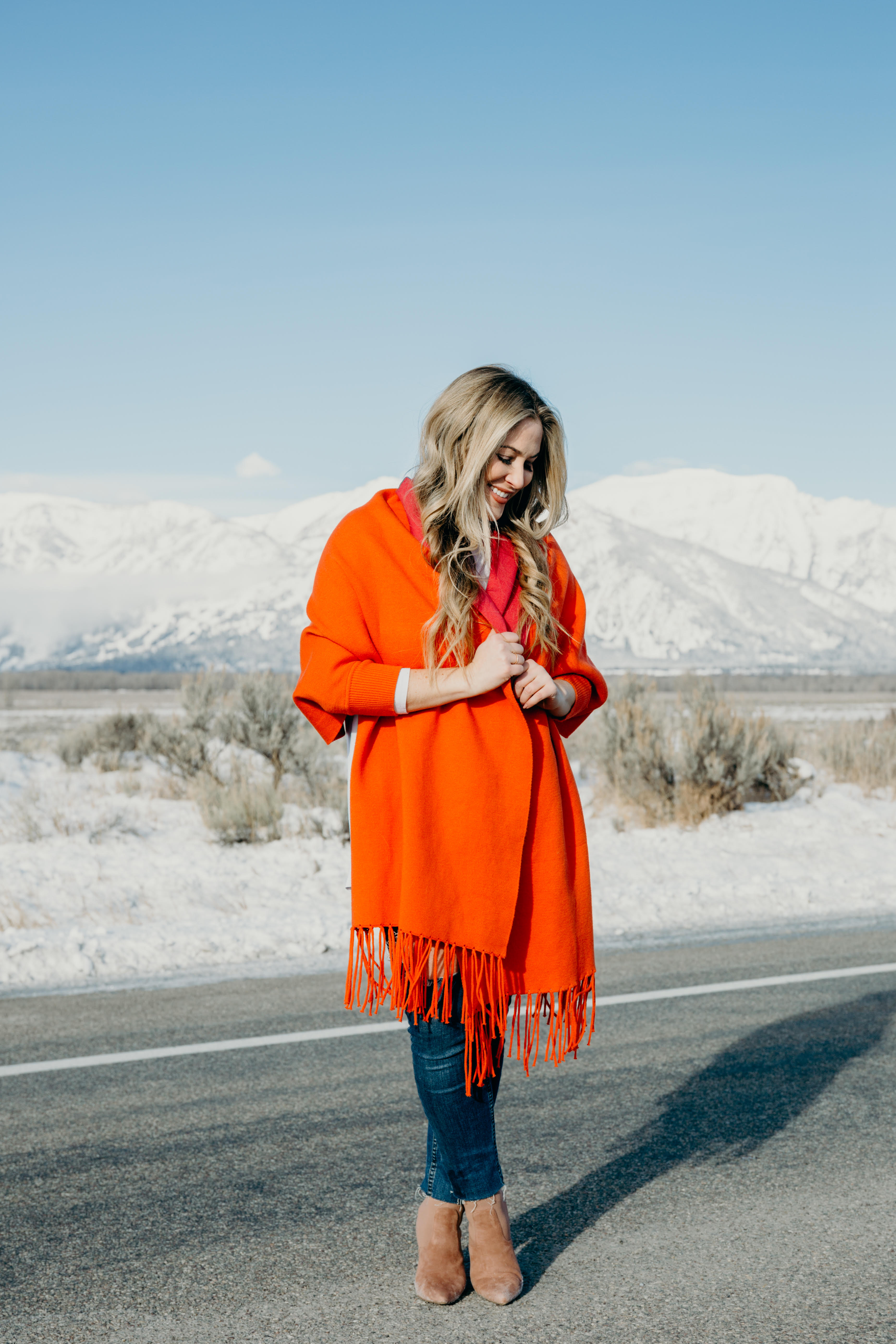 Bright Clothing for Winter featured by top US fashion blog, Walking in Memphis in High Heels: image of a woman wearing a reversible travel wrap