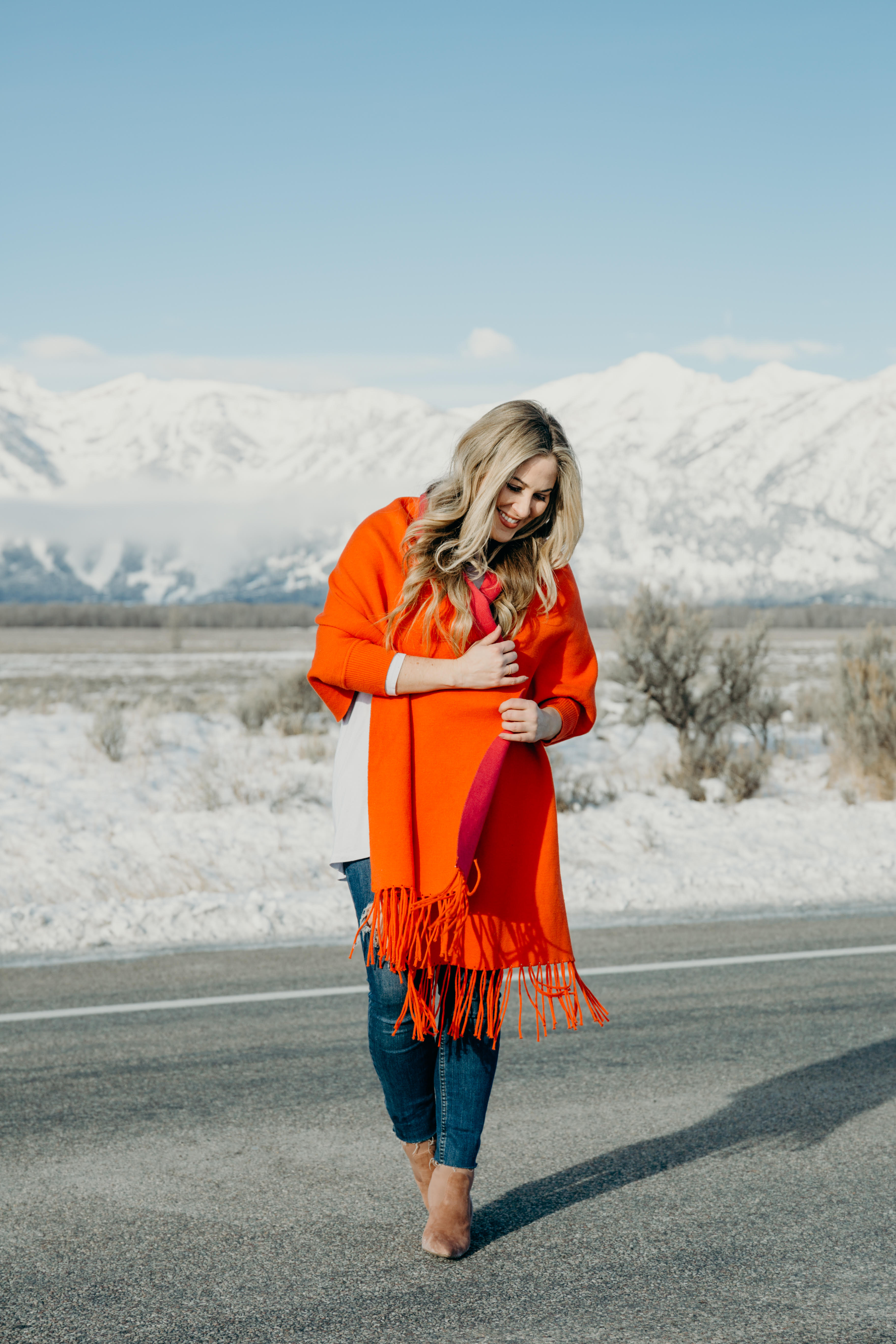 Bright Clothing for Winter featured by top US fashion blog, Walking in Memphis in High Heels: image of a woman wearing a reversible travel wrap