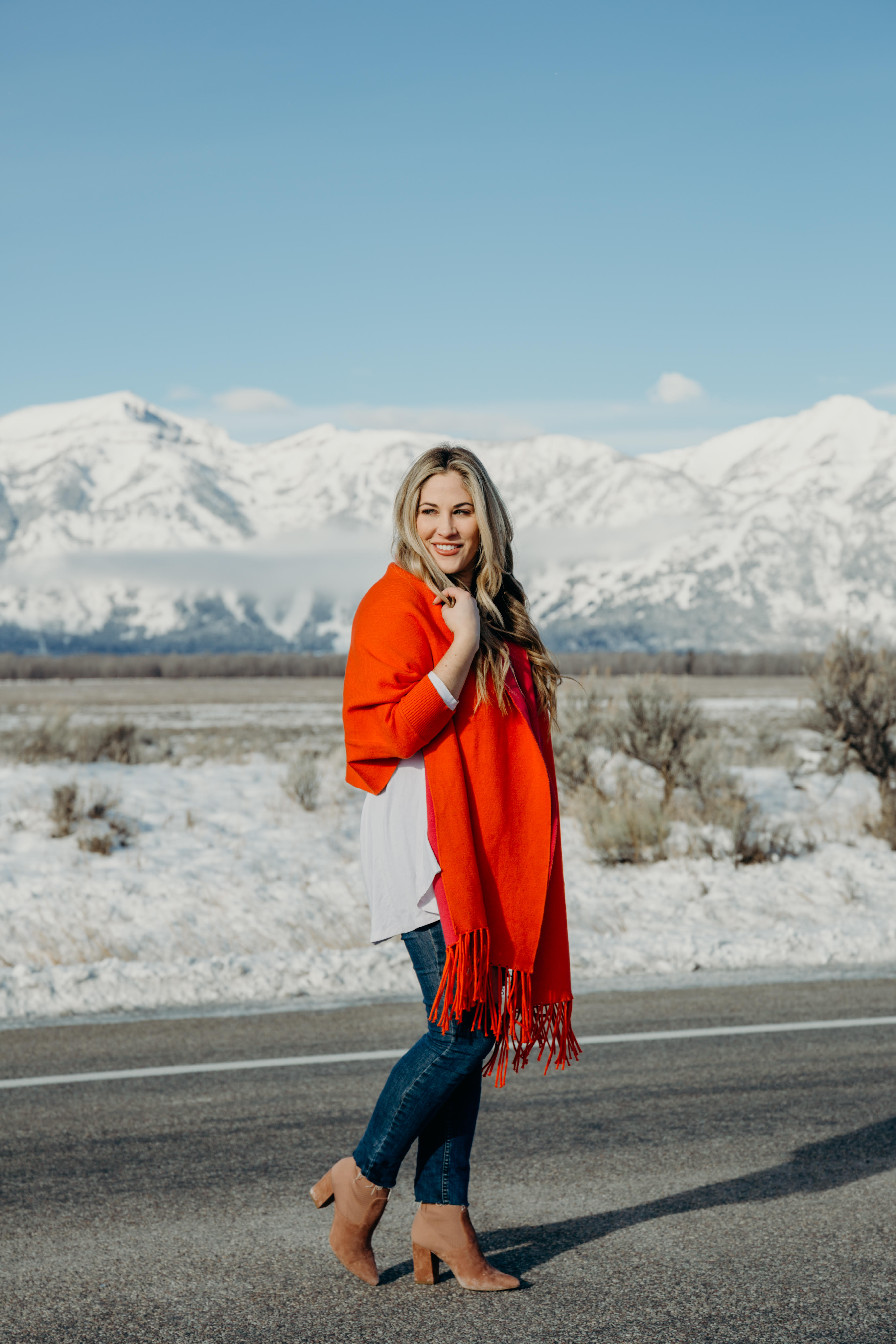 Bright Clothing for Winter featured by top US fashion blog, Walking in Memphis in High Heels: image of a woman wearing a reversible travel wrap