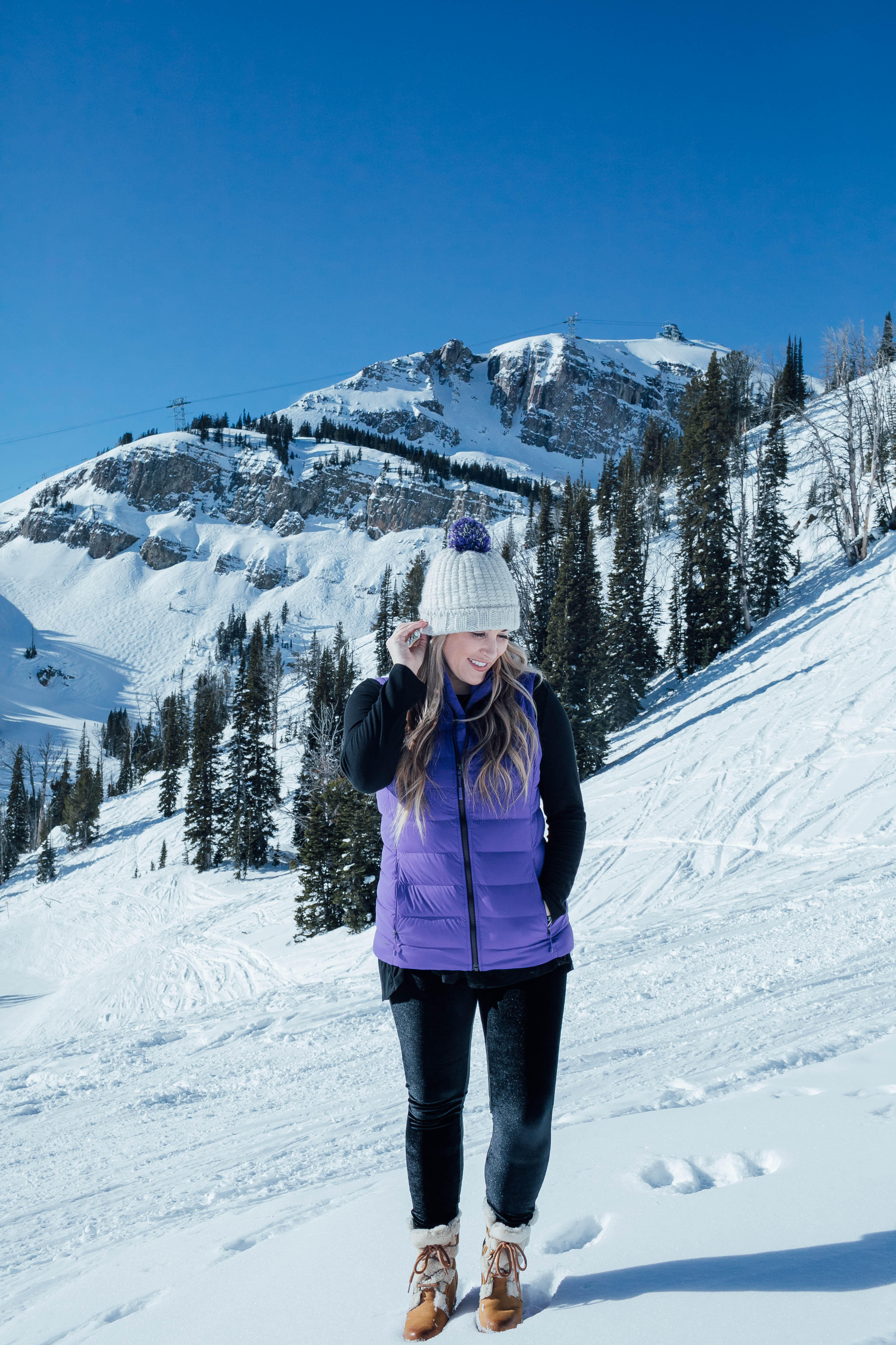 Yummie leggings featured by top US fashion blog, Walking in Memphis in High Heels: image of a woman at a mountain resort wearing Yummie shaping leggings, BP pocket tee, The North Face vest, The North Face pompom beanie hat and Sorel wedge boots