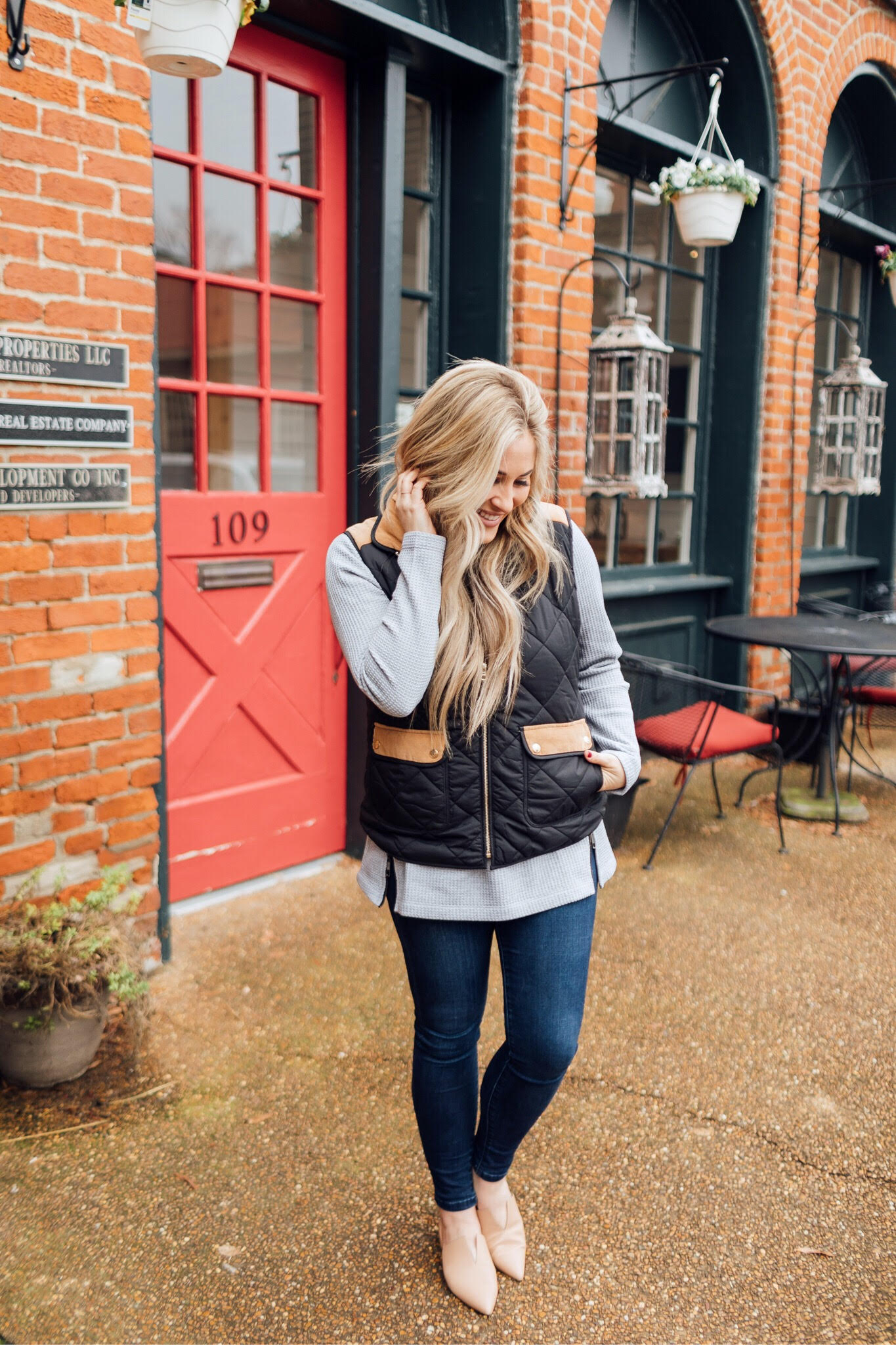 Must have LL Bean thermal top featured by top US fashion blog, Walking in Memphis in High Heels: image of a woman wearing an LL Bean MockNeck Thermal top, Lauren James vest, Joe’s Jeans skinny ankle jeans and Vince Camuto flats.