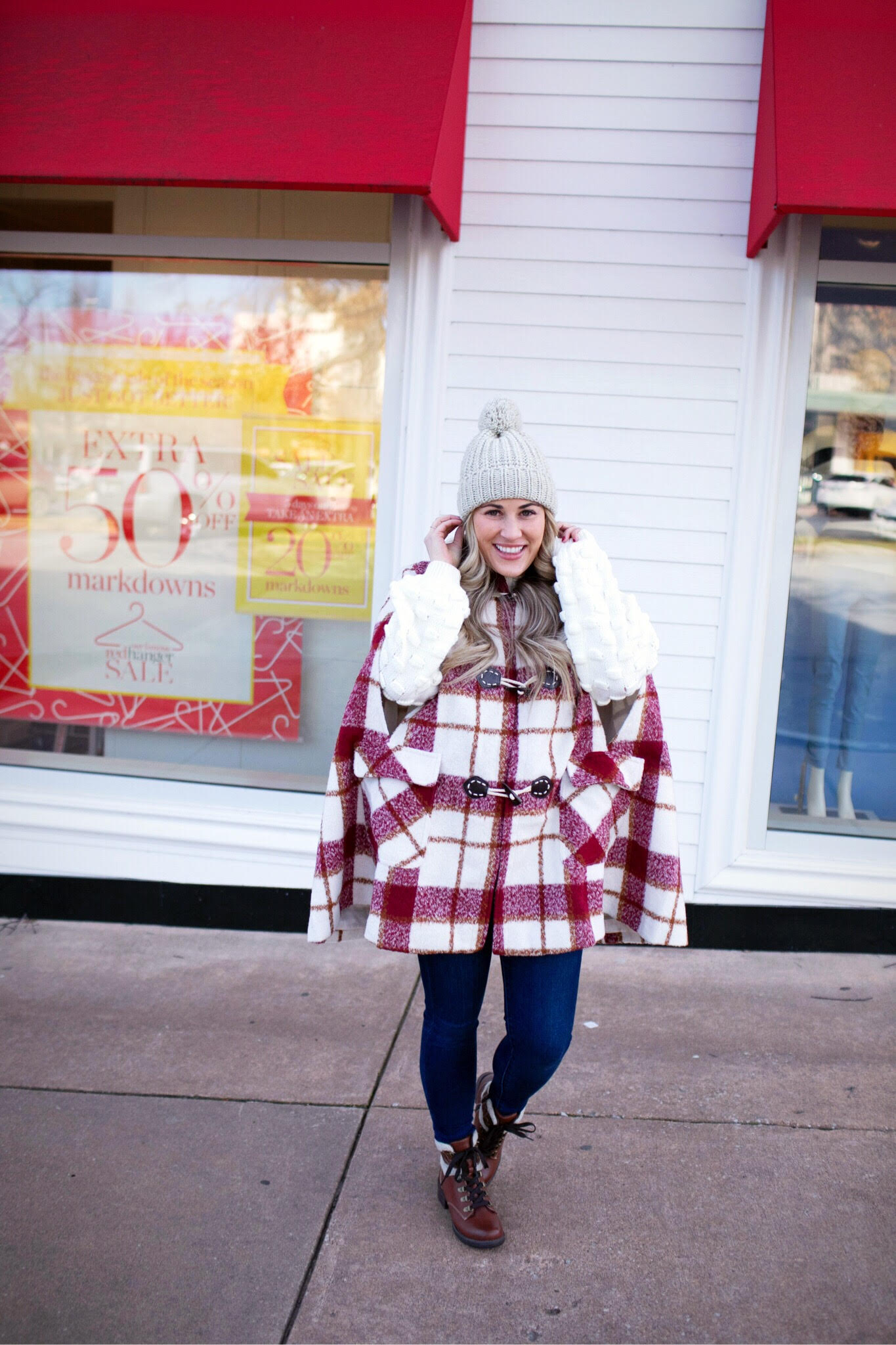 Warm and cute Valentines Day outfit featured by top US fashion blog, Walking in Memphis in High Heels: image of a woman wearing SheIn plaid duffle coat, Joe’s Jeans skinny jeans, Red Dress knit sweater, Eastland Combat Boots and a Faux fur pom beanie hat