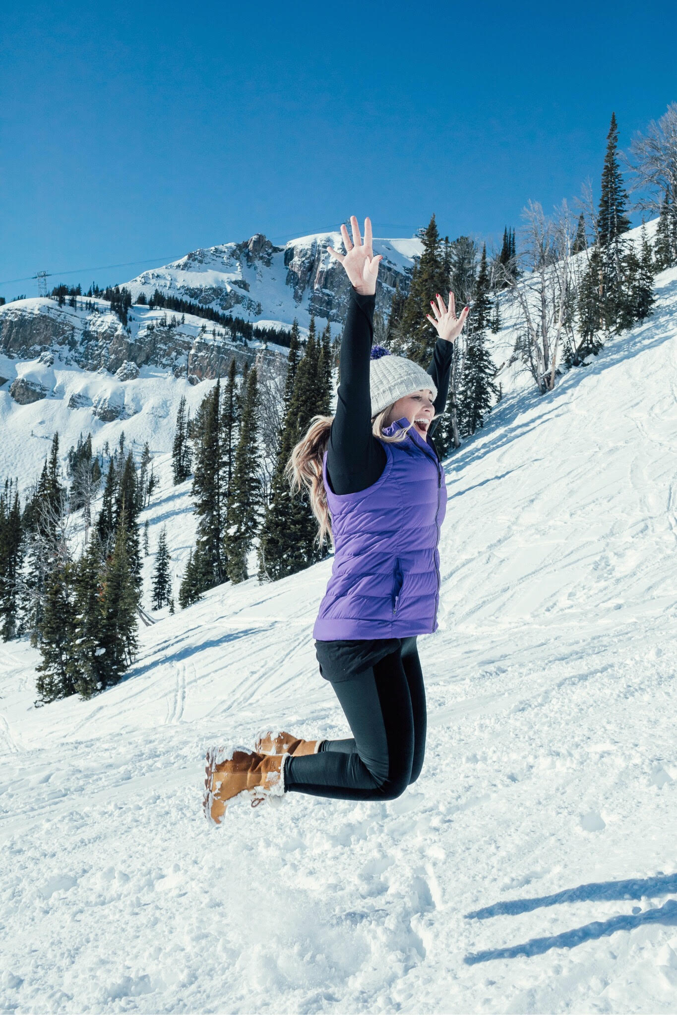 Yummie leggings featured by top US fashion blog, Walking in Memphis in High Heels: image of a woman at a mountain resort wearing Yummie shaping leggings, BP pocket tee, The North Face vest, The North Face pompom beanie hat and Sorel wedge boots