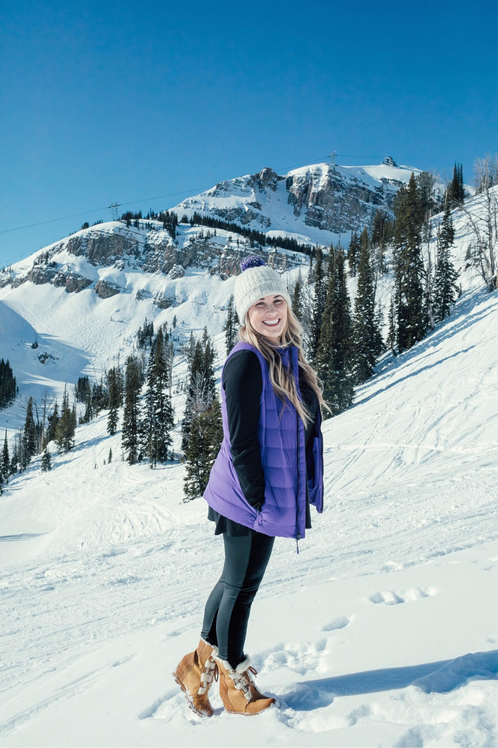 Yummie leggings featured by top US fashion blog, Walking in Memphis in High Heels: image of a woman at a mountain resort wearing Yummie shaping leggings, BP pocket tee, The North Face vest, The North Face pompom beanie hat and Sorel wedge boots