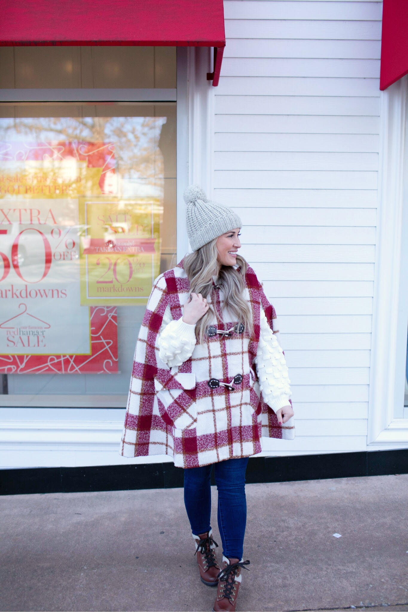 Warm and cute Valentines Day outfit featured by top US fashion blog, Walking in Memphis in High Heels: image of a woman wearing SheIn plaid duffle coat, Joe’s Jeans skinny jeans, Red Dress knit sweater, Eastland Combat Boots and a Faux fur pom beanie hat