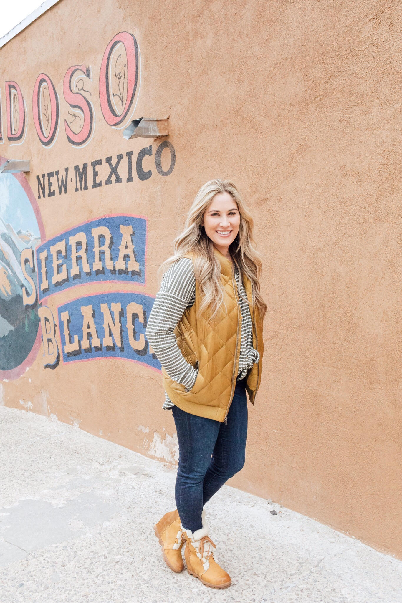 Cute winter sherpa boots styled by top US fashion blog, Walking in Memphis in High Heels: image of a woman wearing a Grace and Lace thermal top, Zappos skinny jeans, Patagonia vest, Sorel sherpa boots and Grace and Lace knit pom beanie