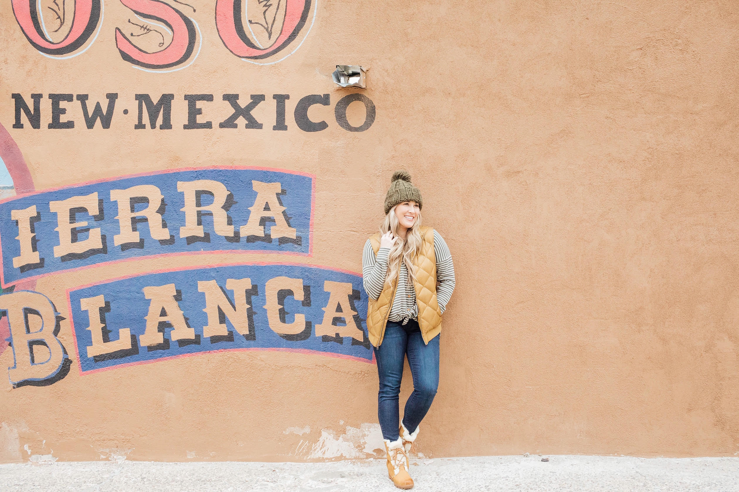 Cute winter sherpa boots styled by top US fashion blog, Walking in Memphis in High Heels: image of a woman wearing a Grace and Lace thermal top, Zappos skinny jeans, Patagonia vest, Sorel sherpa boots and Grace and Lace knit pom beanie