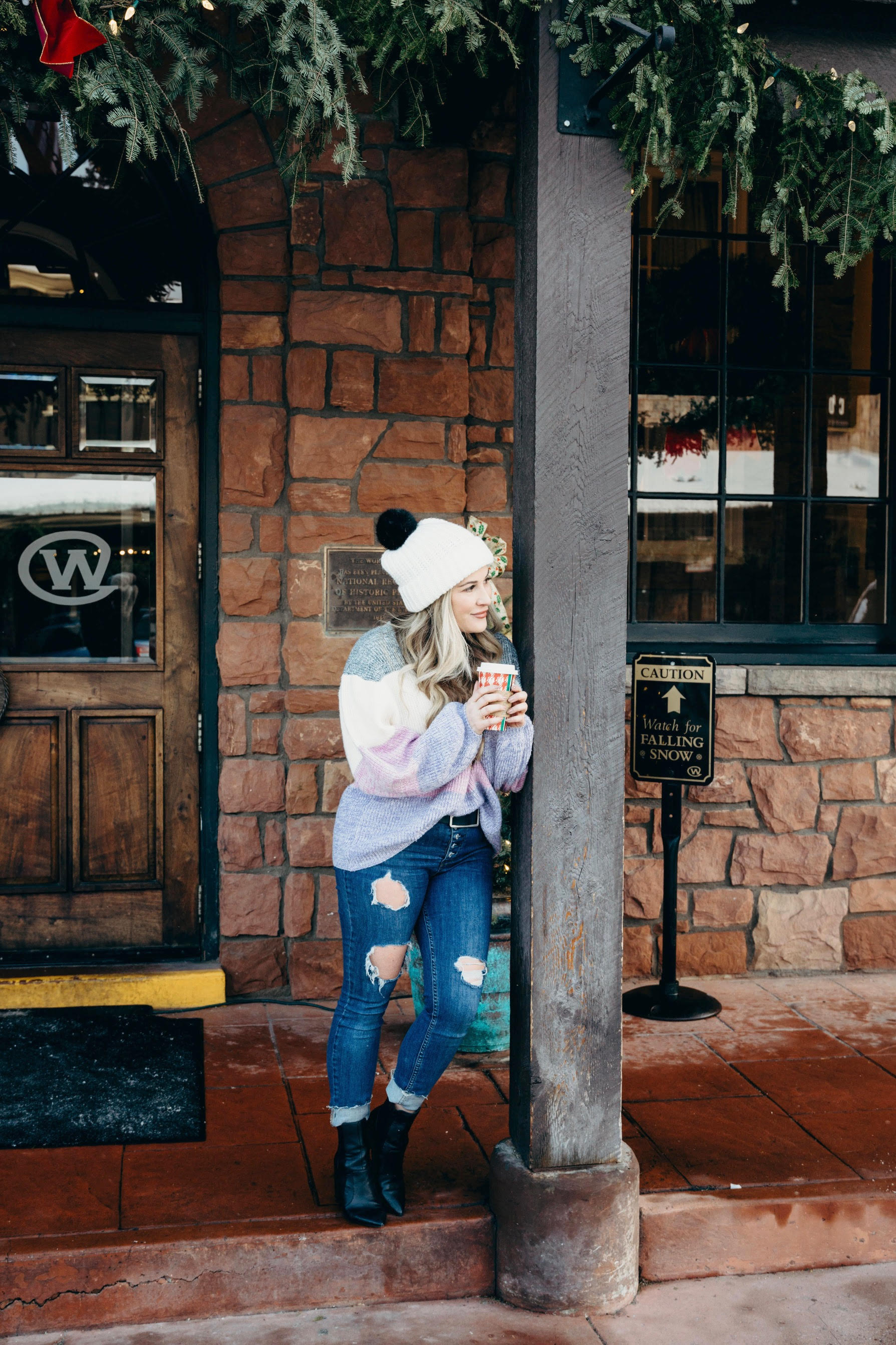 Pink Lily striped sweater styled by top US fashion blog, Walking in Memphis in High Heels: image of a woman wearing a Pink Lily striped sweater, Free People skinny jeans, Double faux fur pom pom beanie and Sole Society sole booties