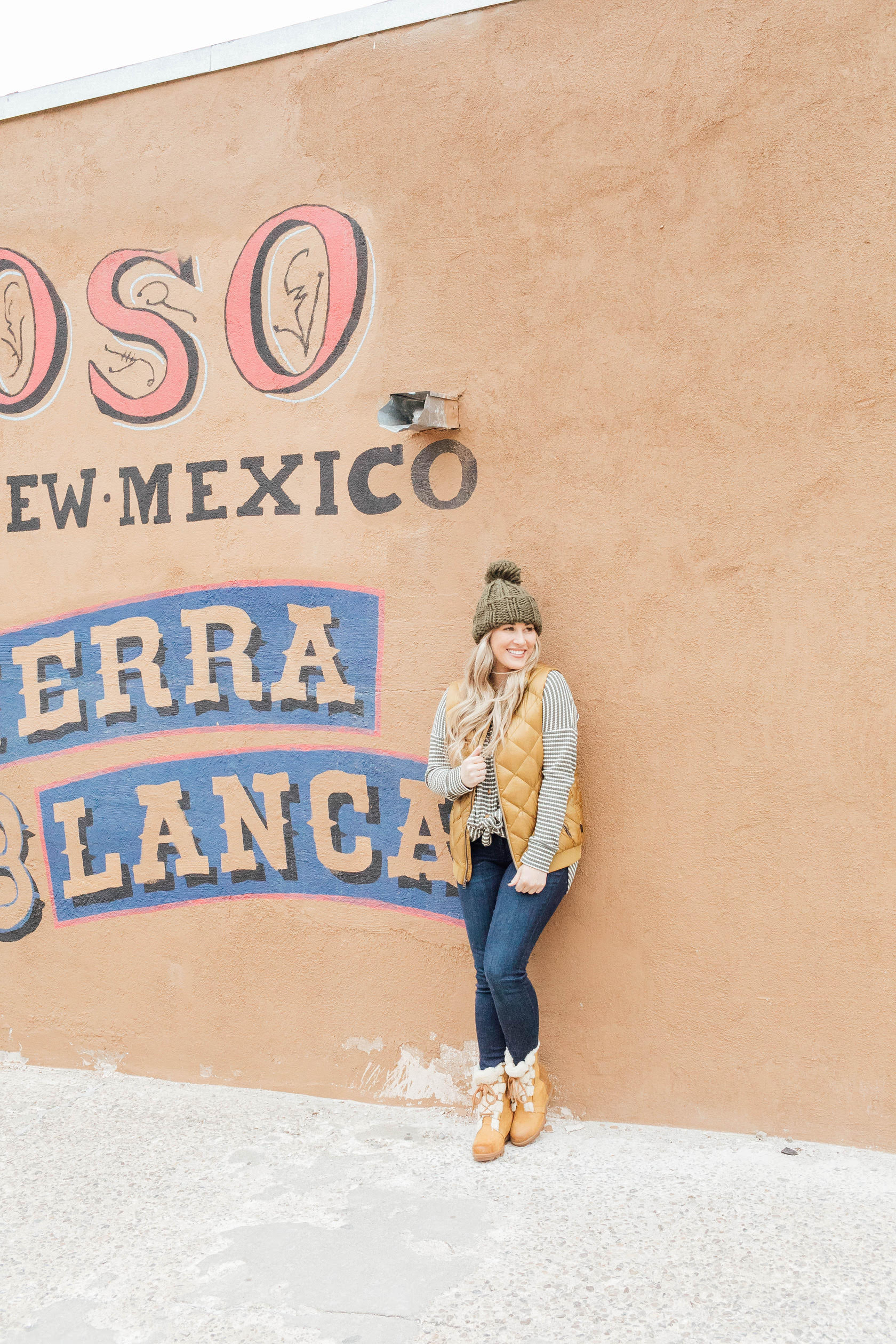 Cute winter sherpa boots styled by top US fashion blog, Walking in Memphis in High Heels: image of a woman wearing a Grace and Lace thermal top, Zappos skinny jeans, Patagonia vest, Sorel sherpa boots and Grace and Lace knit pom beanie