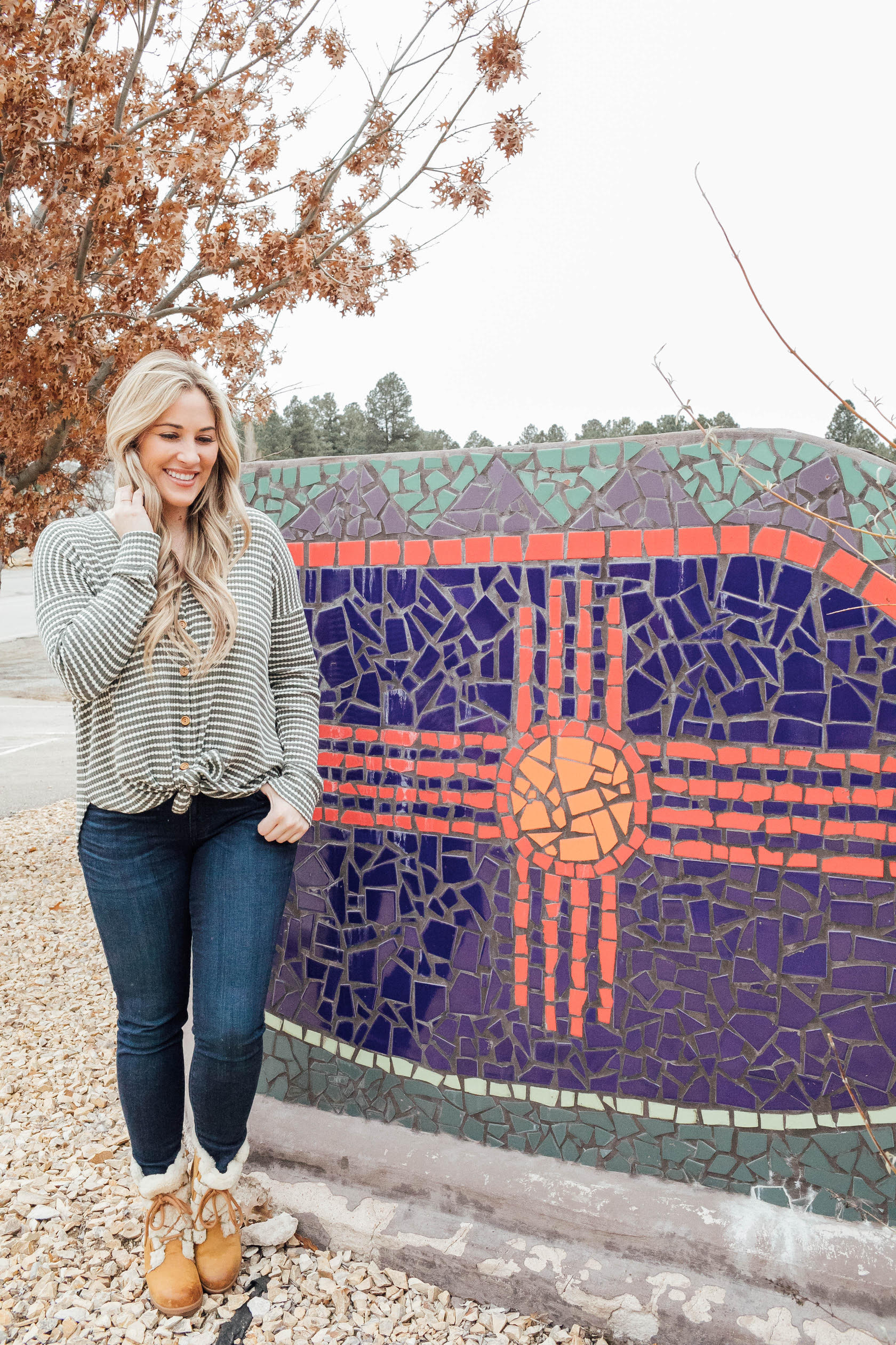 Cute winter sherpa boots styled by top US fashion blog, Walking in Memphis in High Heels: image of a woman wearing a Grace and Lace thermal top, Zappos skinny jeans, Patagonia vest, Sorel sherpa boots and Grace and Lace knit pom beanie