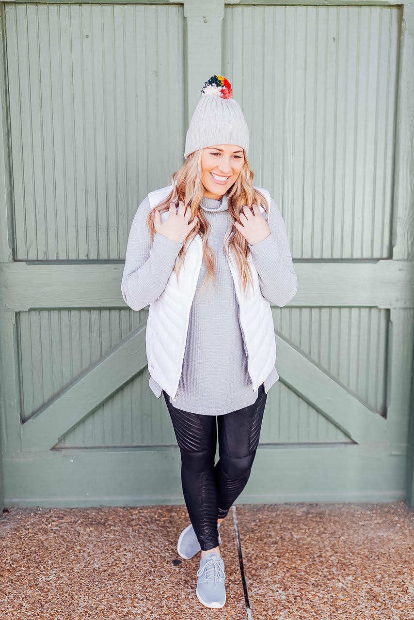 4 ways to style your Spanx Faux Leather Leggings featured by top US fashion blog, Walking in Memphis in High Heels: image of a woman wearing Spanx faux leather leggings, LL Bean Tunic, The North Face vest, Nike Roshe One sneakers