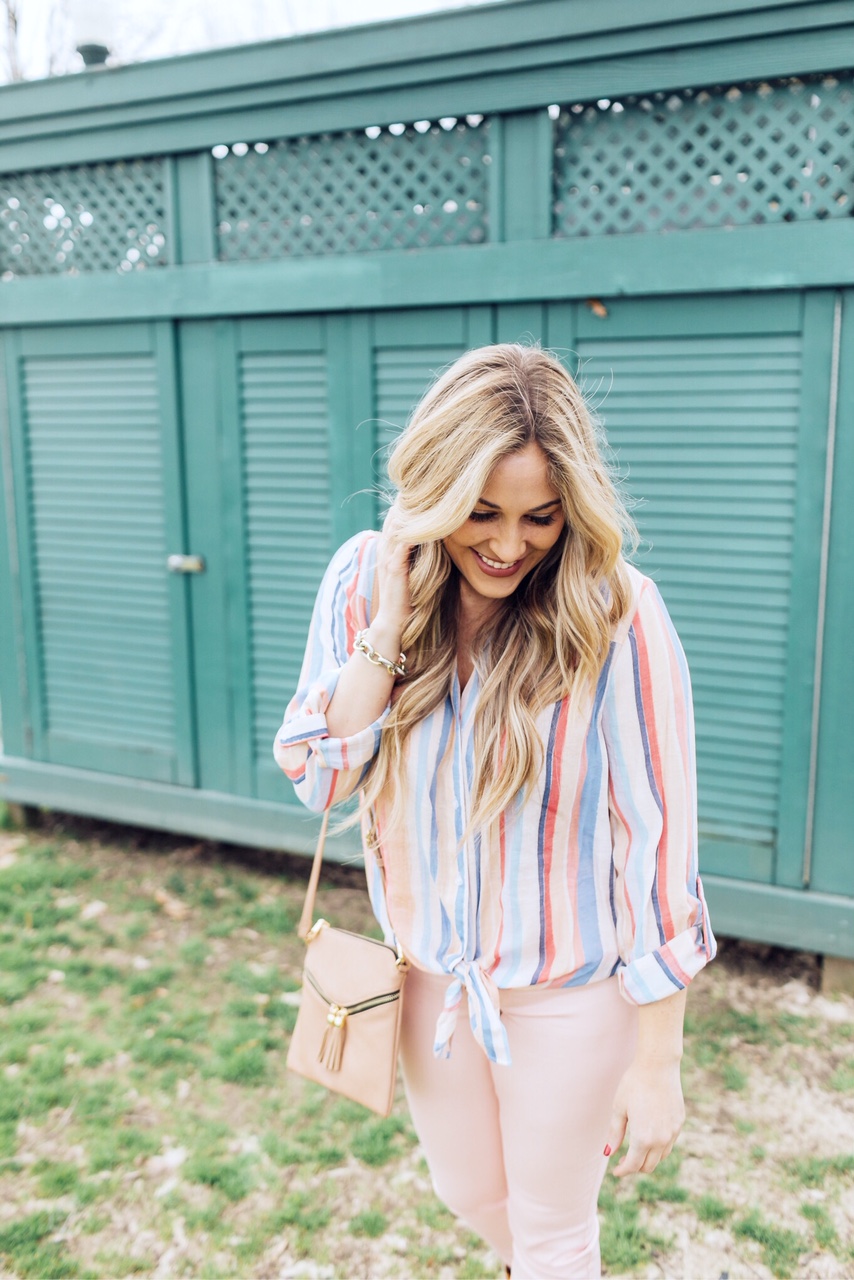 Spring outfit from Gordmans styled by top US fashion blog, Walking in Memphis in High Heels: image of a woman wearing peach jeans, striped button down shirt, and a crossbody bag