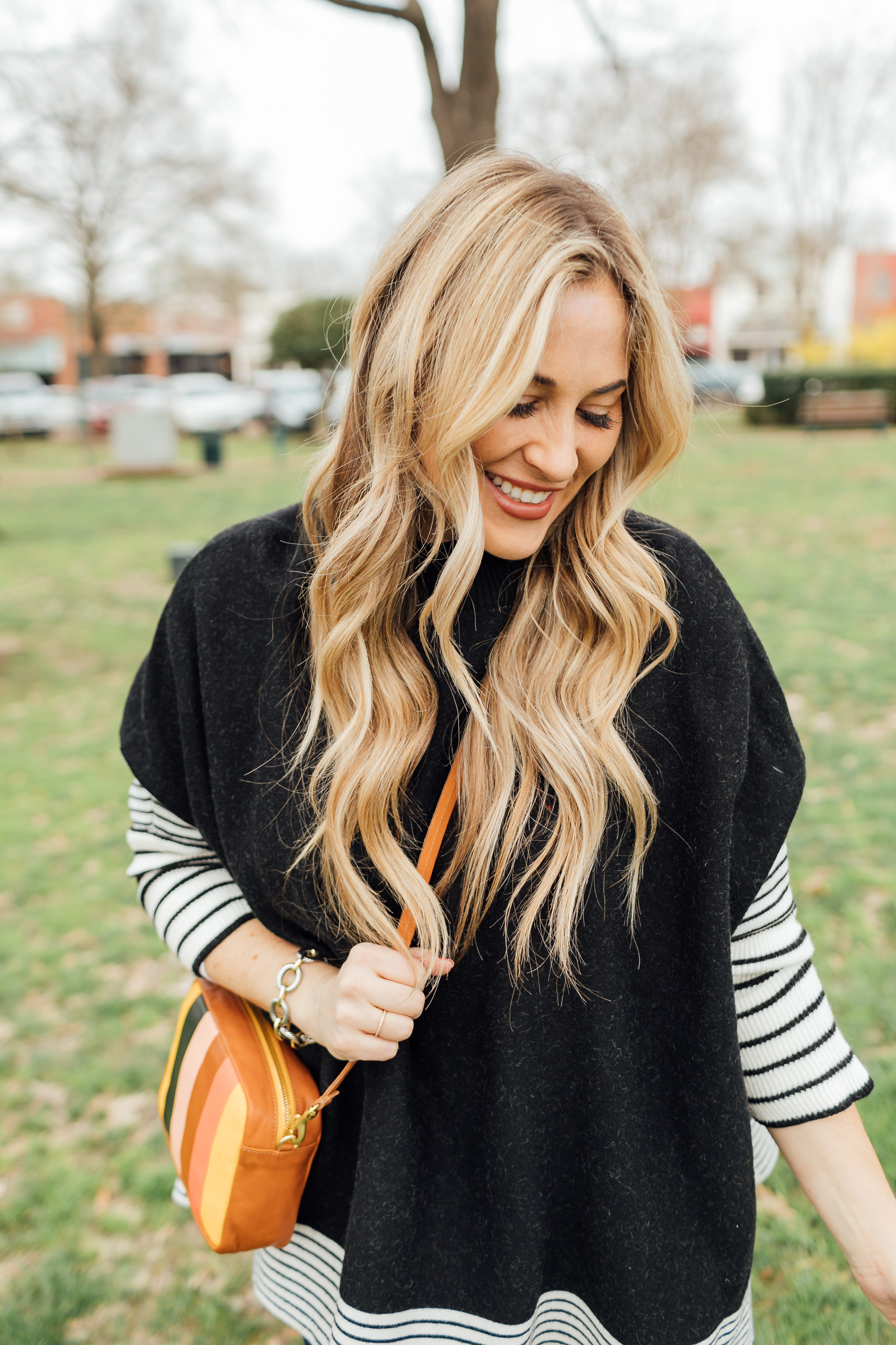 Colorful outfit featured by top US fashion blog, Walking in Memphis in High Heels: image of a woman wearing a Good American skinny jeans, a SheIn striped poncho jumper, Goodnight Macaroons suede over the knee boots and a Steve Madden crossbody bag