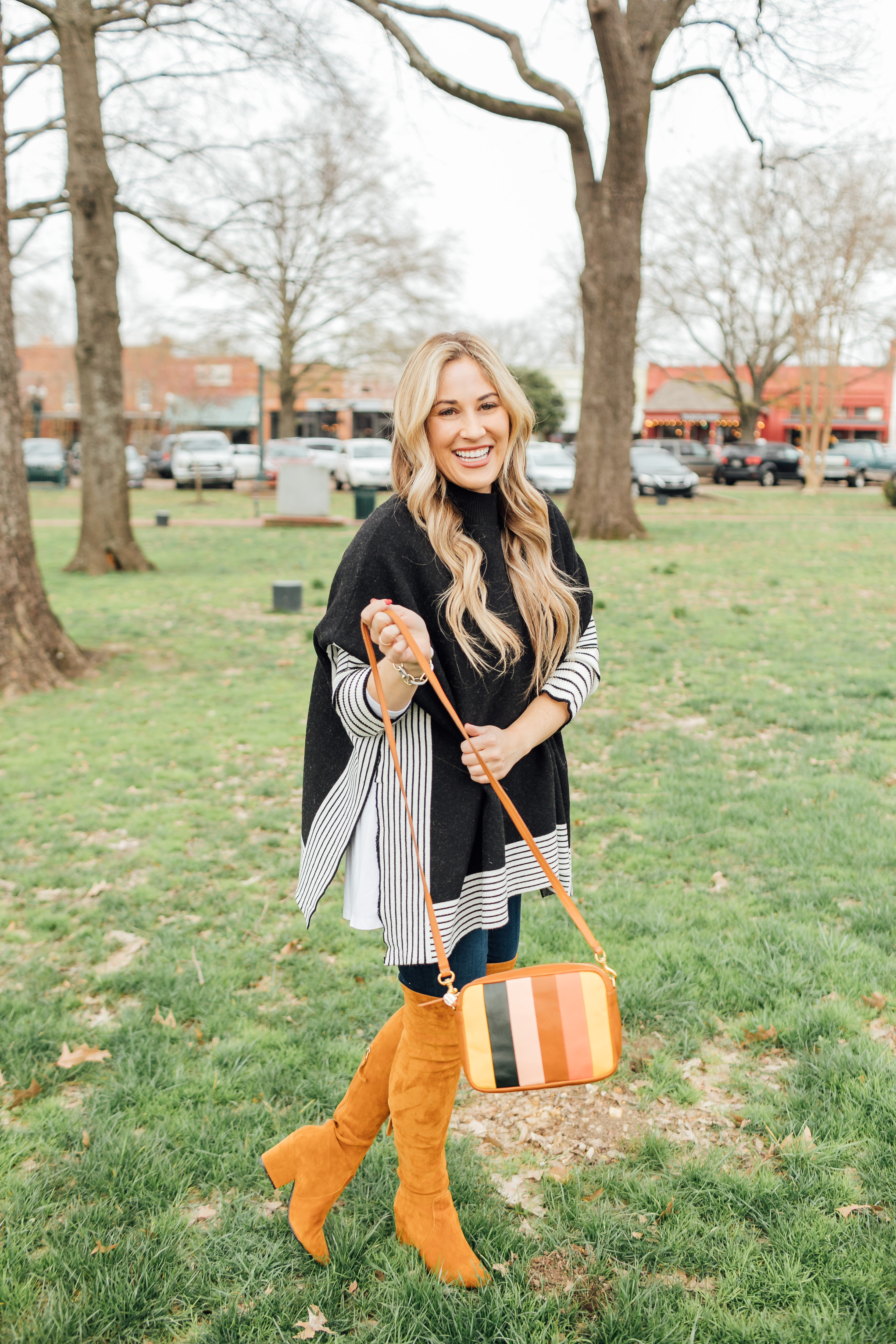 Colorful outfit featured by top US fashion blog, Walking in Memphis in High Heels: image of a woman wearing a Good American skinny jeans, a SheIn striped poncho jumper, Goodnight Macaroons suede over the knee boots and a Steve Madden crossbody bag