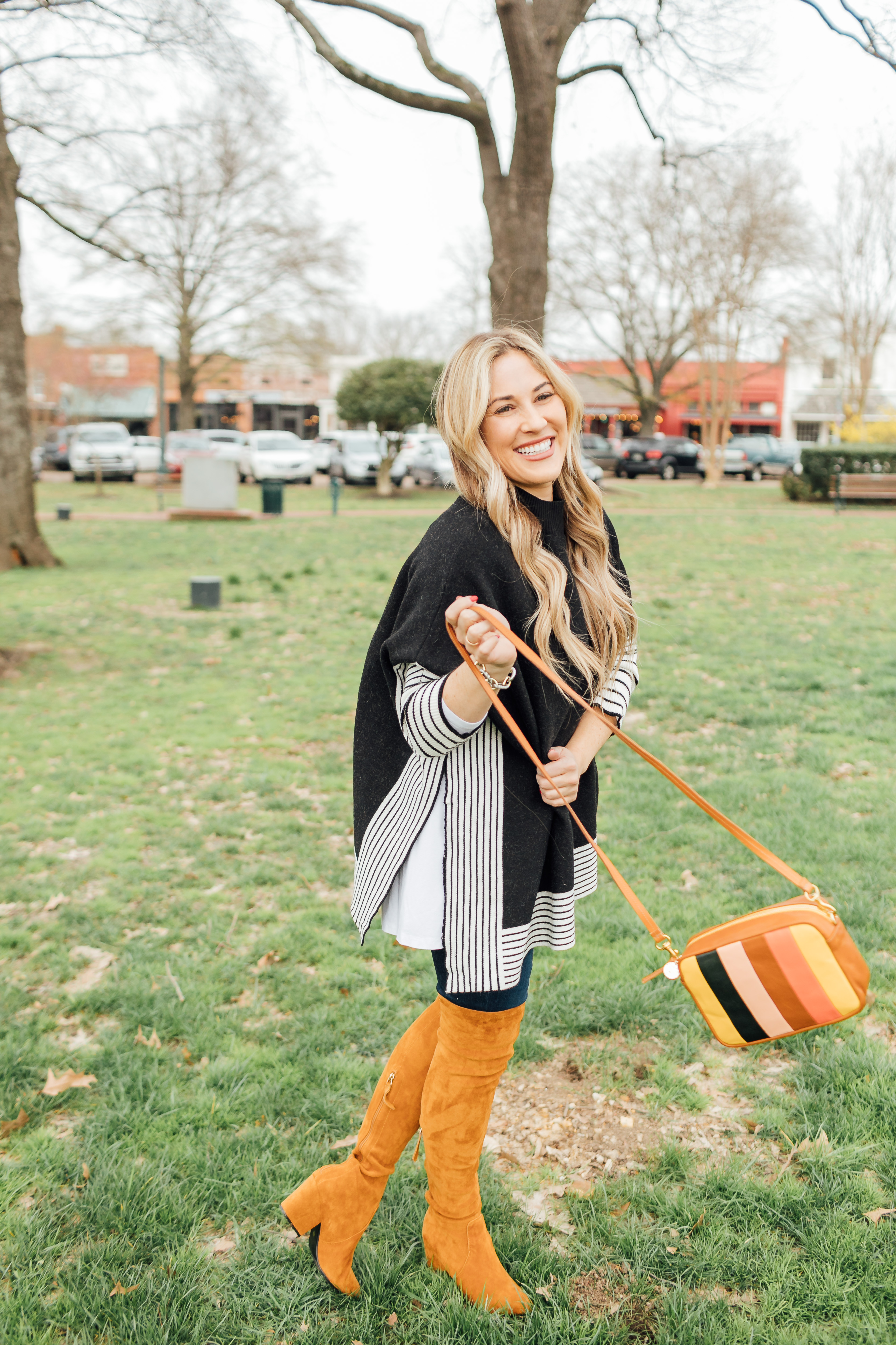 Colorful outfit featured by top US fashion blog, Walking in Memphis in High Heels: image of a woman wearing a Good American skinny jeans, a SheIn striped poncho jumper, Goodnight Macaroons suede over the knee boots and a Steve Madden crossbody bag