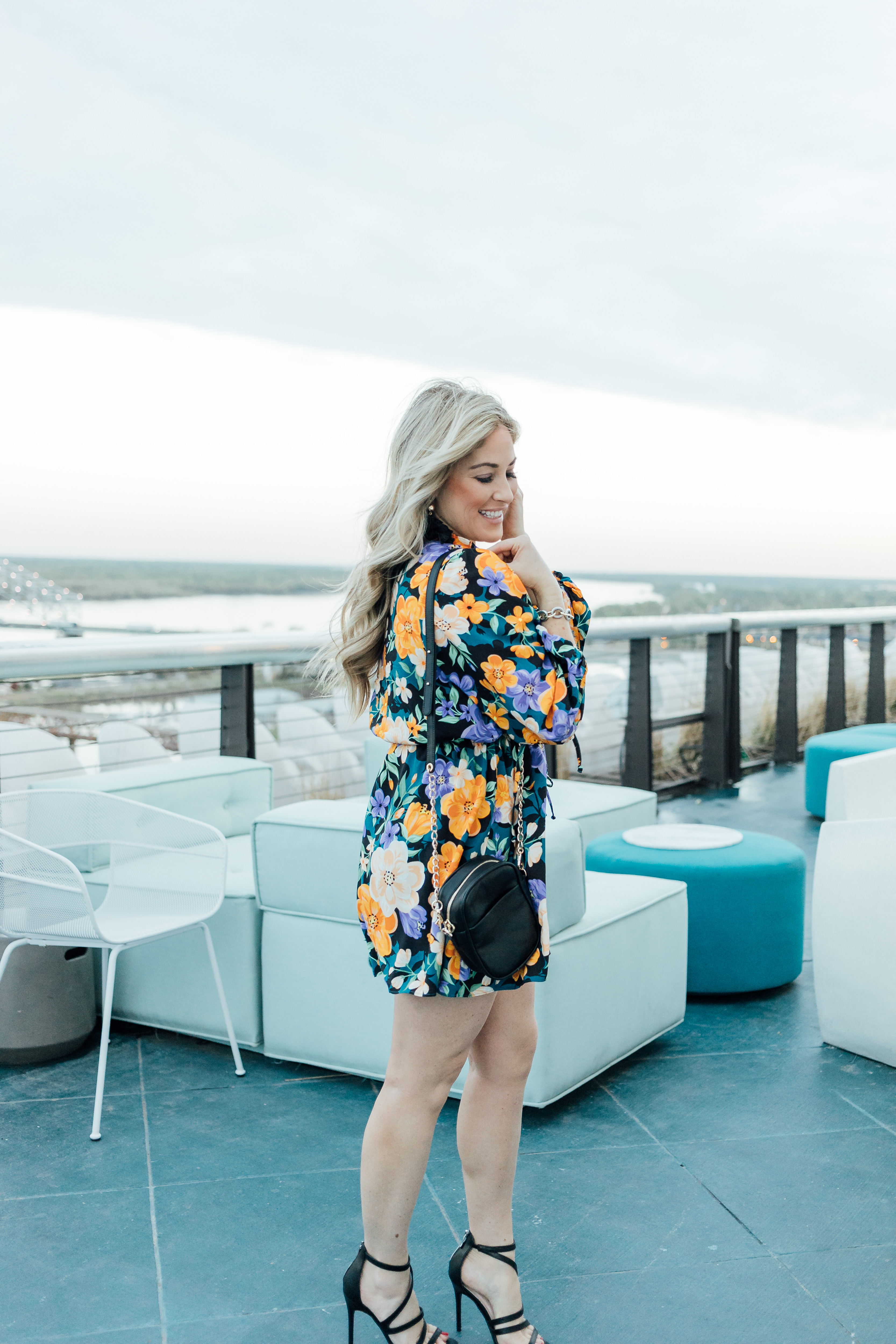 Hu Hotel review featured by top Memphis blog, Walking in Memphis in High Heels: image of a woman wearing a Tularosa mini floral dress, Steve Madden dress sandals and a Kate Spade smart phone crossbody bag.