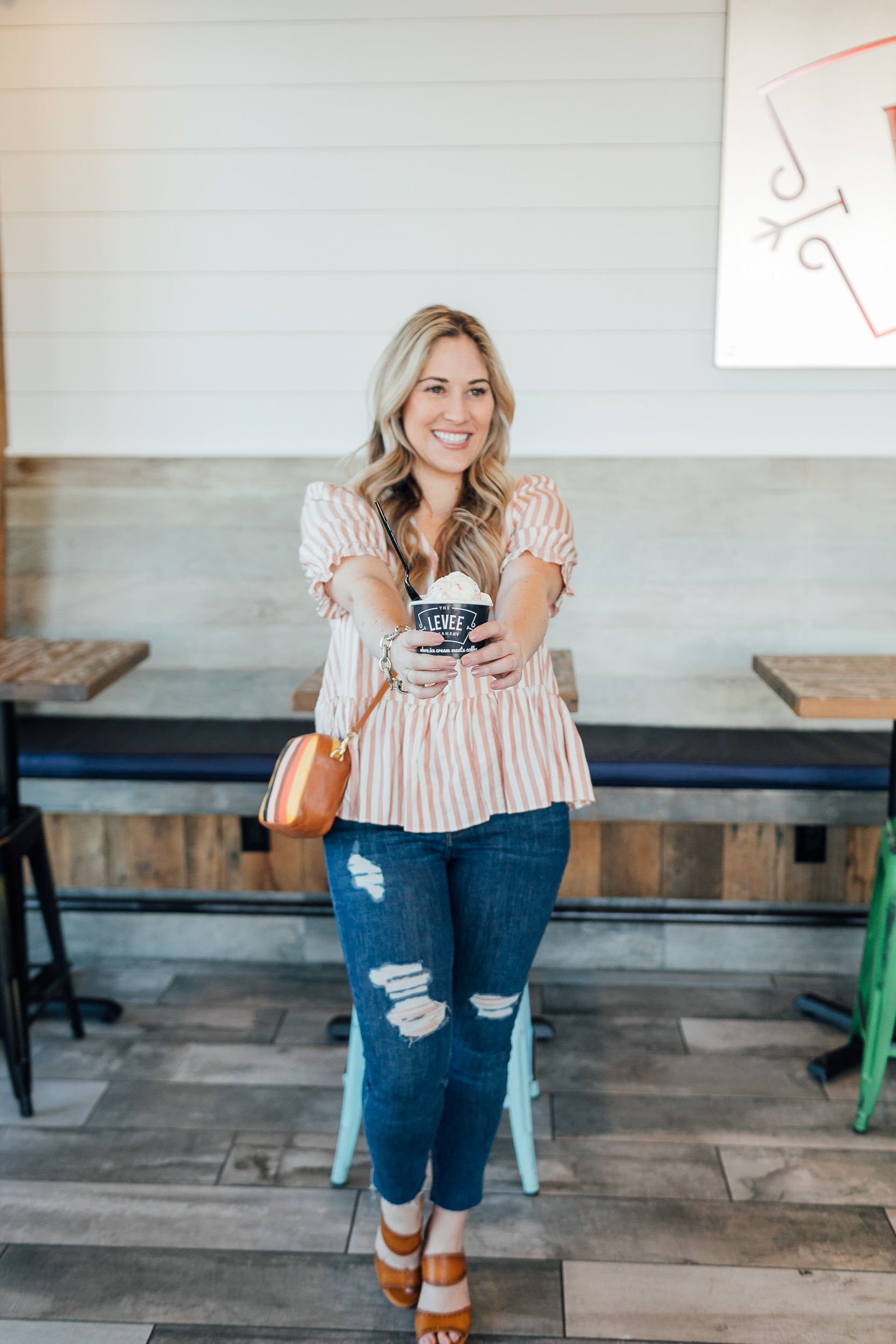 Madewell striped peplum top styled for Spring, featured by top US fashion blog, Walking in Memphis in High Heels: image of a woman wearing a Madewell top, Free People skinny jeans, Zappos sandals, and a Steve Madden crossbody bag.