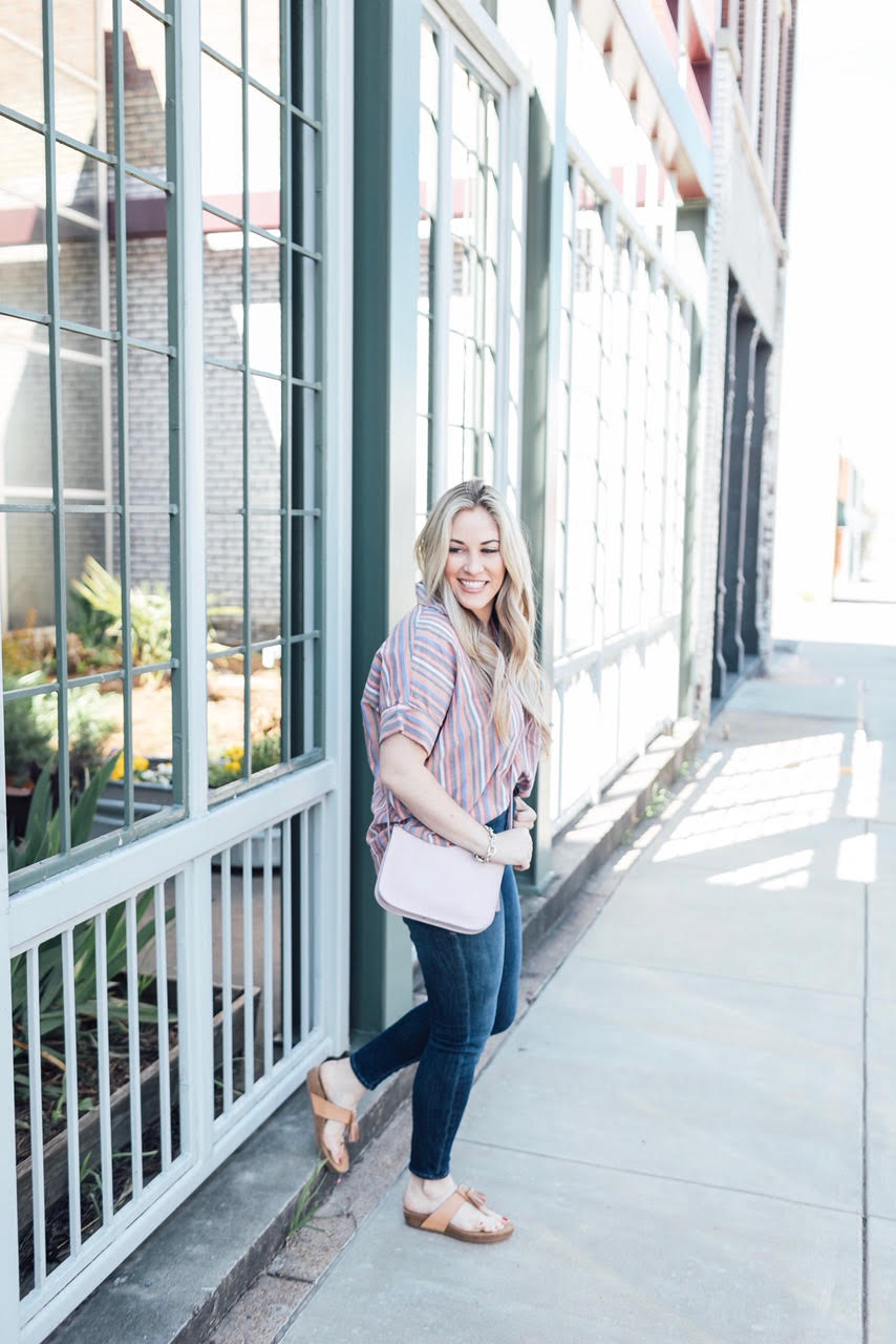 Comfortiva Gella tassel sandals style by top US fashion blog, Walking in Memphis in High Heels: image of a woman wearing a Madewell striped shirt, Good American skinny jeans, a Madewell crossbody bag, and Comfortiva Gella tassel sandals