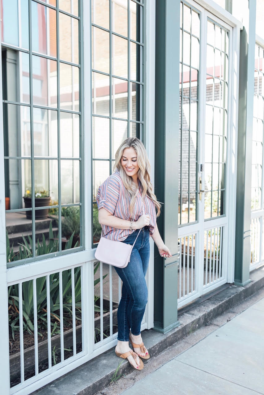 Comfortiva Gella tassel sandals style by top US fashion blog, Walking in Memphis in High Heels: image of a woman wearing a Madewell striped shirt, Good American skinny jeans, a Madewell crossbody bag, and Comfortiva Gella tassel sandals