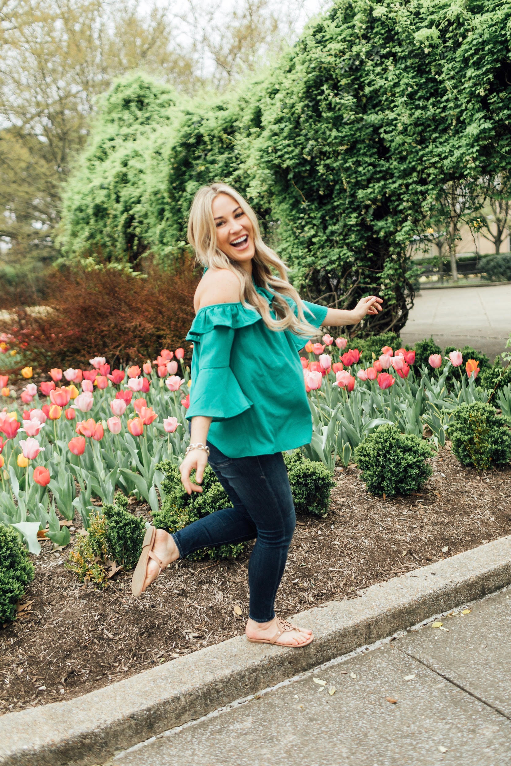 How to Get Cute Family Pictures with Your Child featured by top US life and style blog, Walking in Memphis in High Heels: image of a woman wearing a BB Dakota off the shoulder blouse, Good American skinny jeans, Tory Burch flies flops.