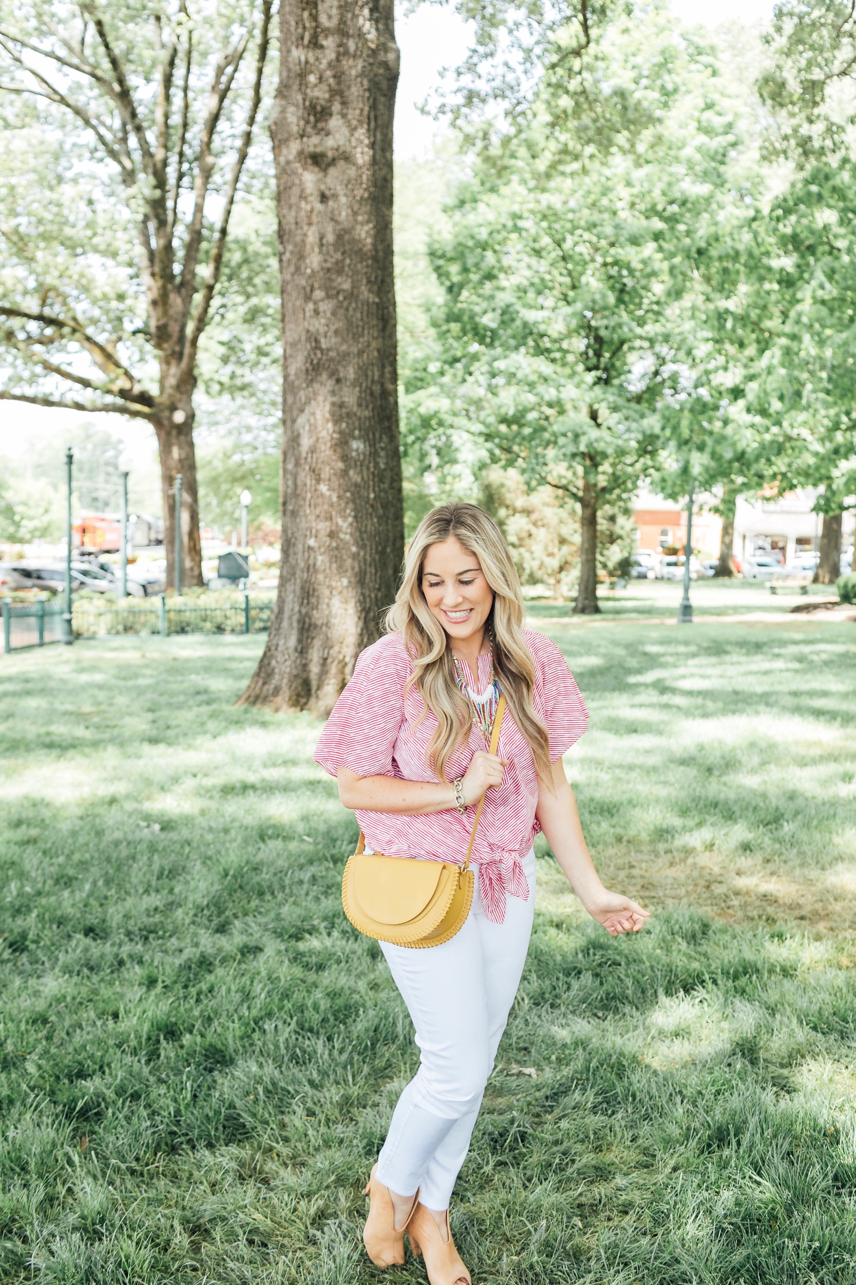 The 5 Most Flattering White Jeans for Summer featured by top US fashion blog, Walking in Memphis in High Heels: image of a woman wearing Chico’s no stain flattering white jeans, Chico’s striped sleeve top, Chico’s colorful bead necklace, and Vince Camuto shorties