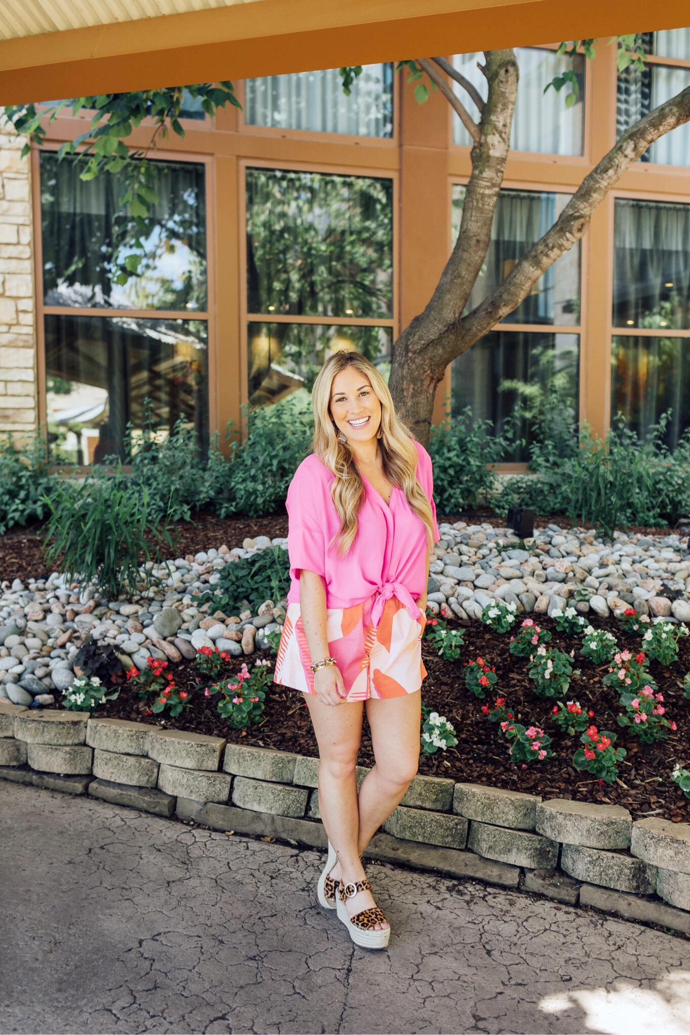 Cute summer shoes featured by top US fashion blog, Walking in Memphis in High Heels: image of a woman wearing March Fisher platform espadrille leopard sandals, Pink Lily Boutique pink blouse, and Thredup shorts