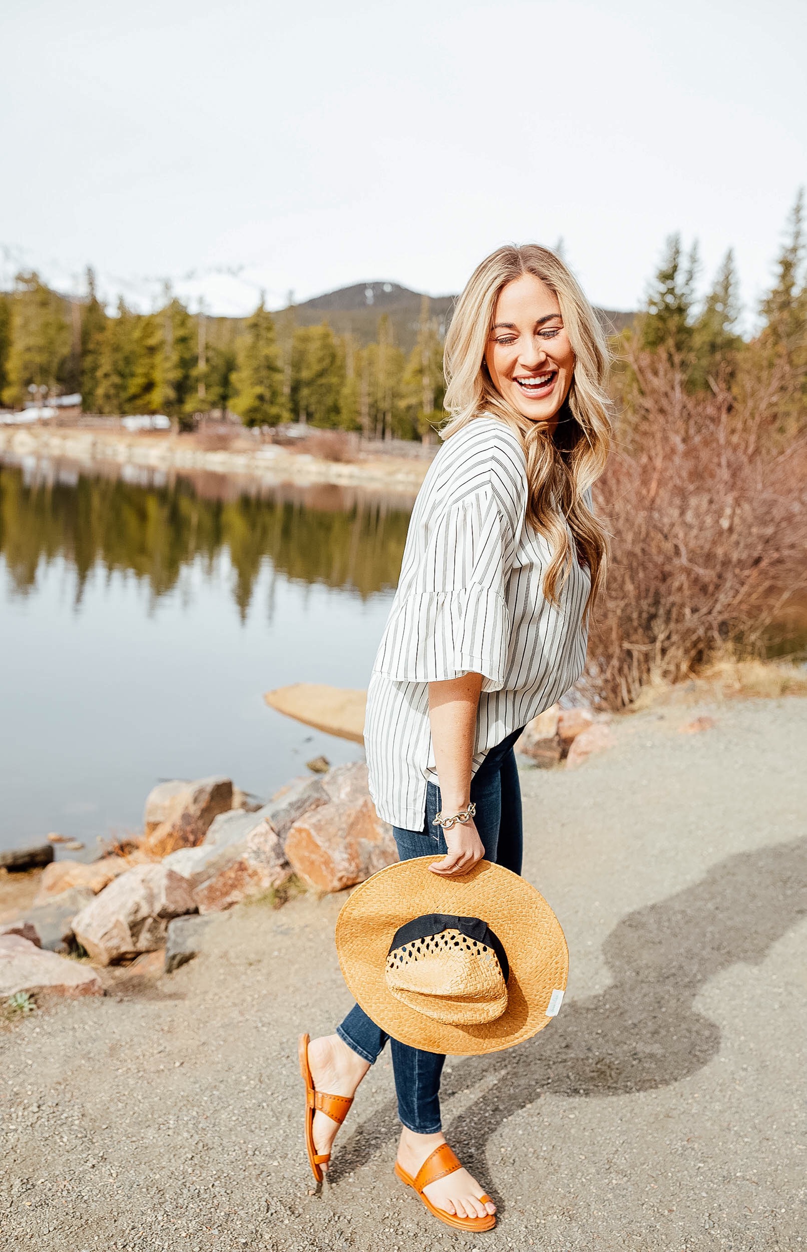 Grace & Lace Panama straw hat styled for the summer by top US fashion blog, Walking in Memphis in High Heels: image of a woman wearing a Grace & Lace Panama straw hat, Grace & Lace striped top, Good American high waist skinny jeans, and Zappos gipsy sandals