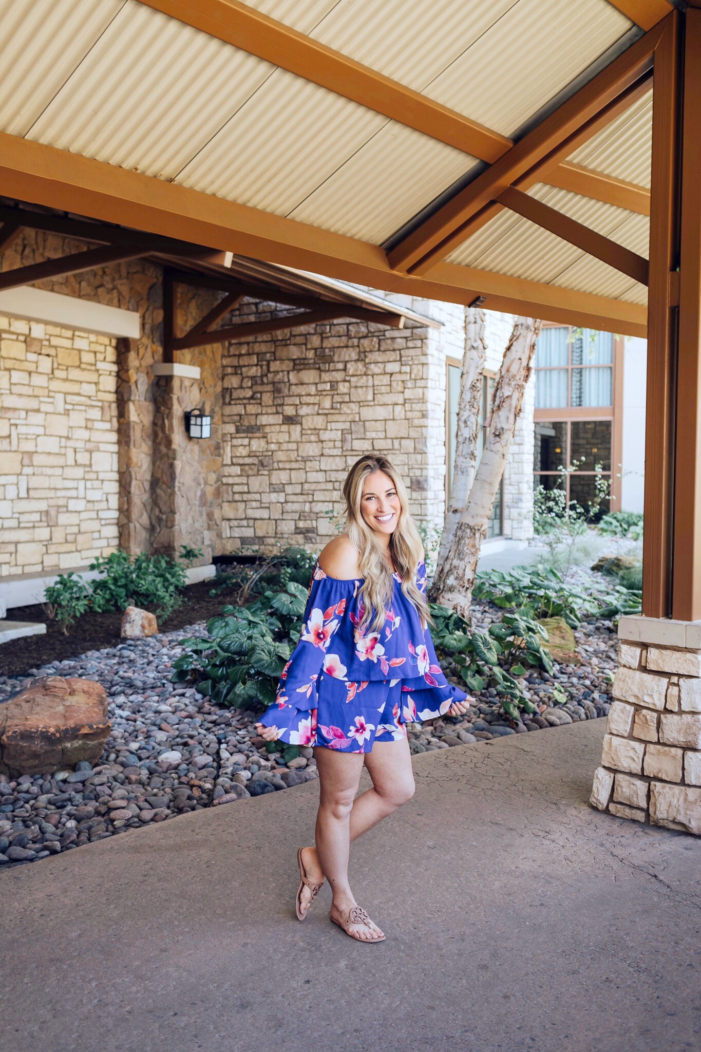 Summer colors styled by top US fashion blog, Walking in Memphis in High Heels: image of a woman wearing a colorful flower romper, and Tory Burch sandals.