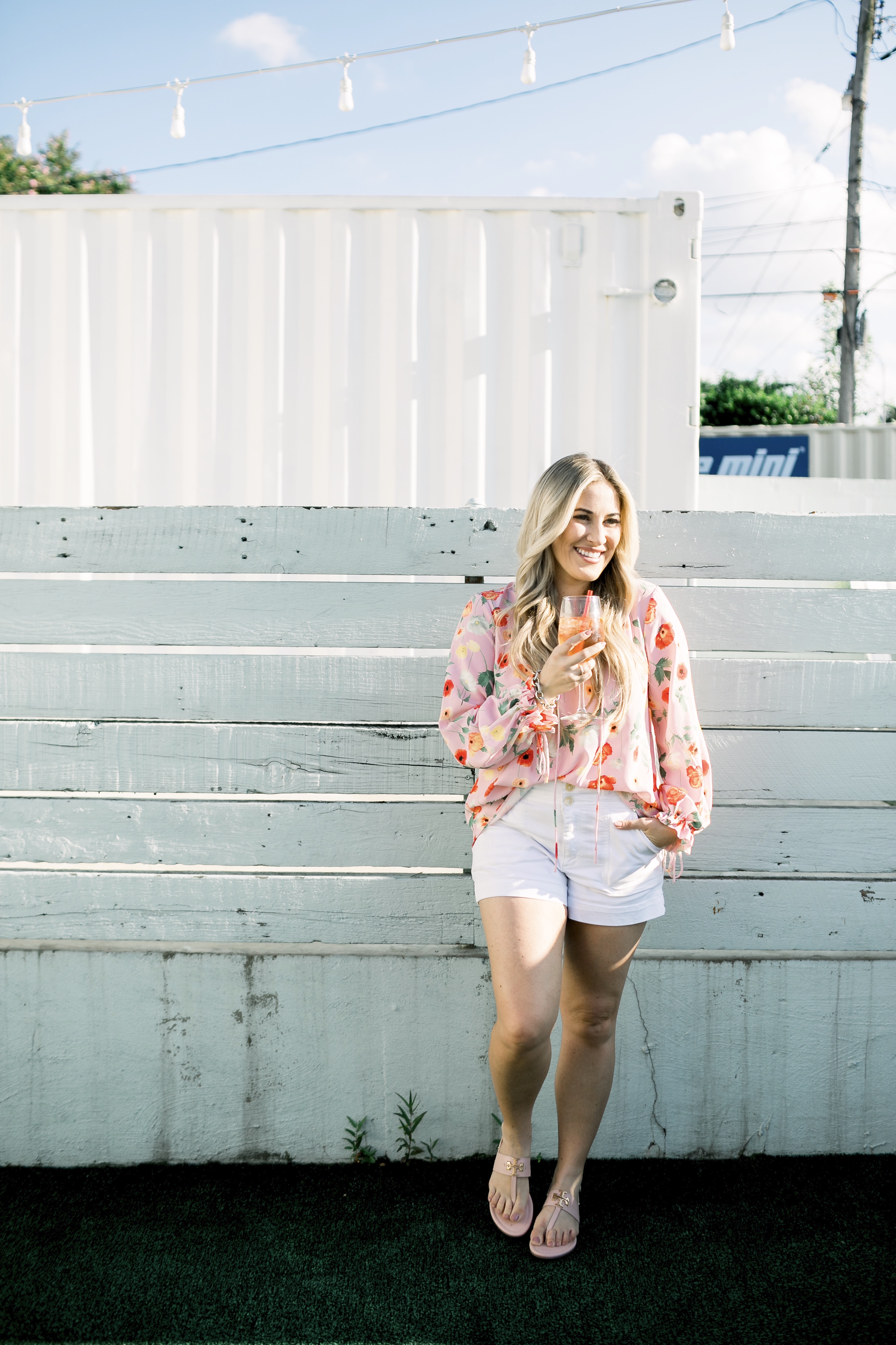 Bright summer colors fashion featured by top US fashion blog, Walking in Memphis in High Heels: image of a woman wearing a Gibson & Latimer floral shirt, Anthropologie high waisted white denim shorts, Tory Burch Miller flip flops and a David Yurman bracelet