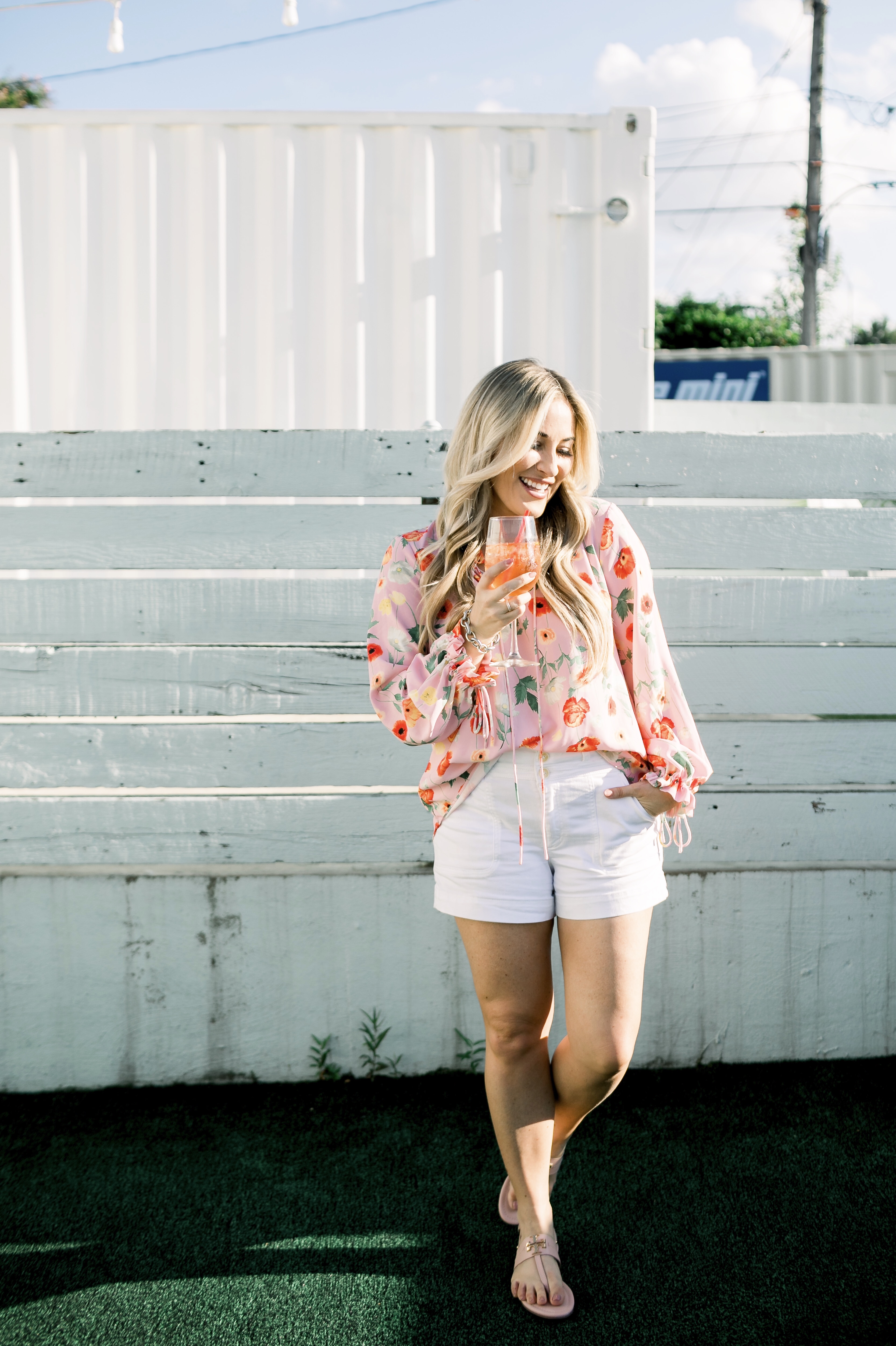 Bright summer colors fashion featured by top US fashion blog, Walking in Memphis in High Heels: image of a woman wearing a Gibson & Latimer floral shirt, Anthropologie high waisted white denim shorts, Tory Burch Miller flip flops and a David Yurman bracelet