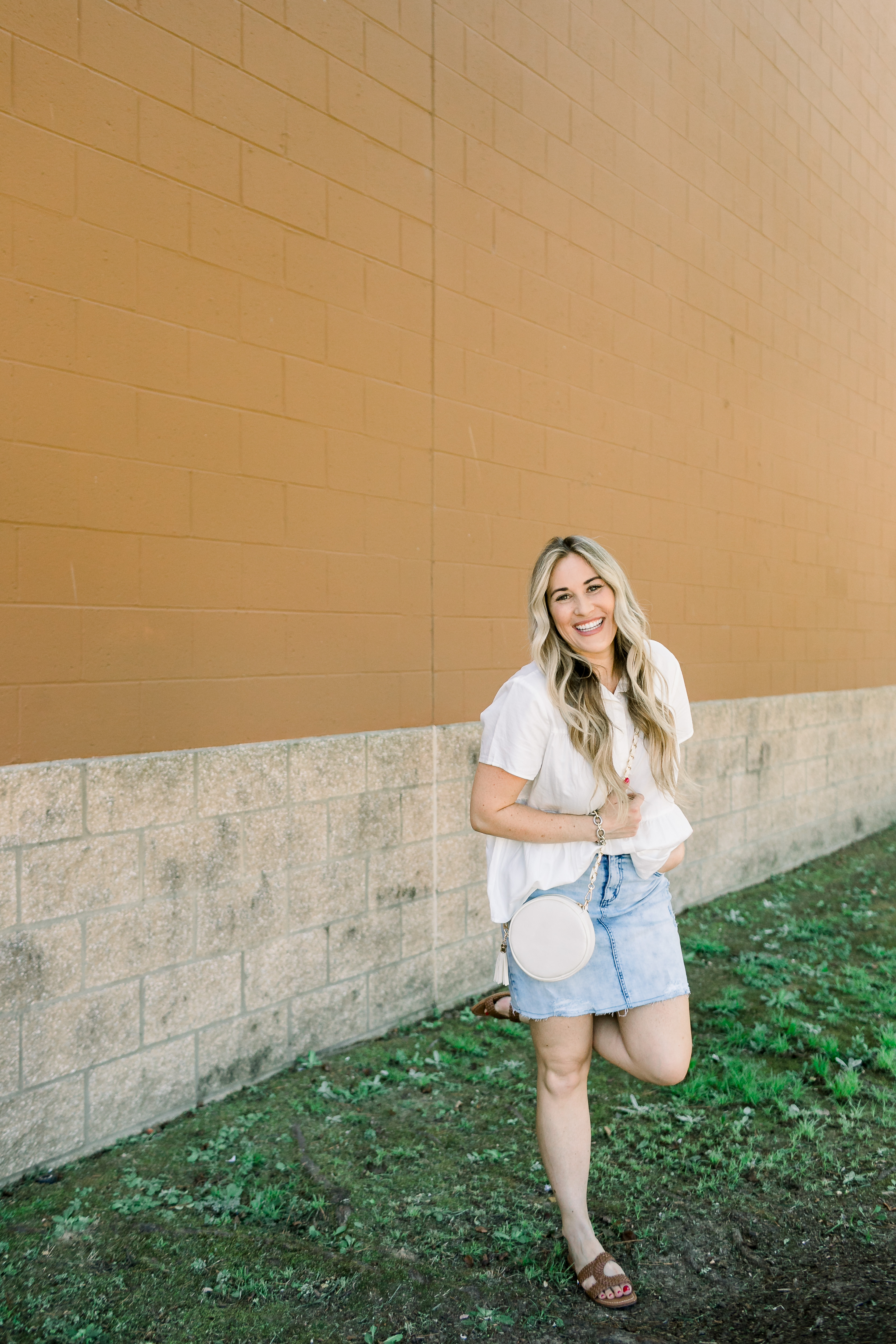 Cute college outfit from Walmart styled by top US fashion blog, Walking in Memphis in High Heels: image of a woman wearing a Time and Tru top, Sofia Jeans by Sofia Vergara denim skirt, and Sam Edelman sandals.