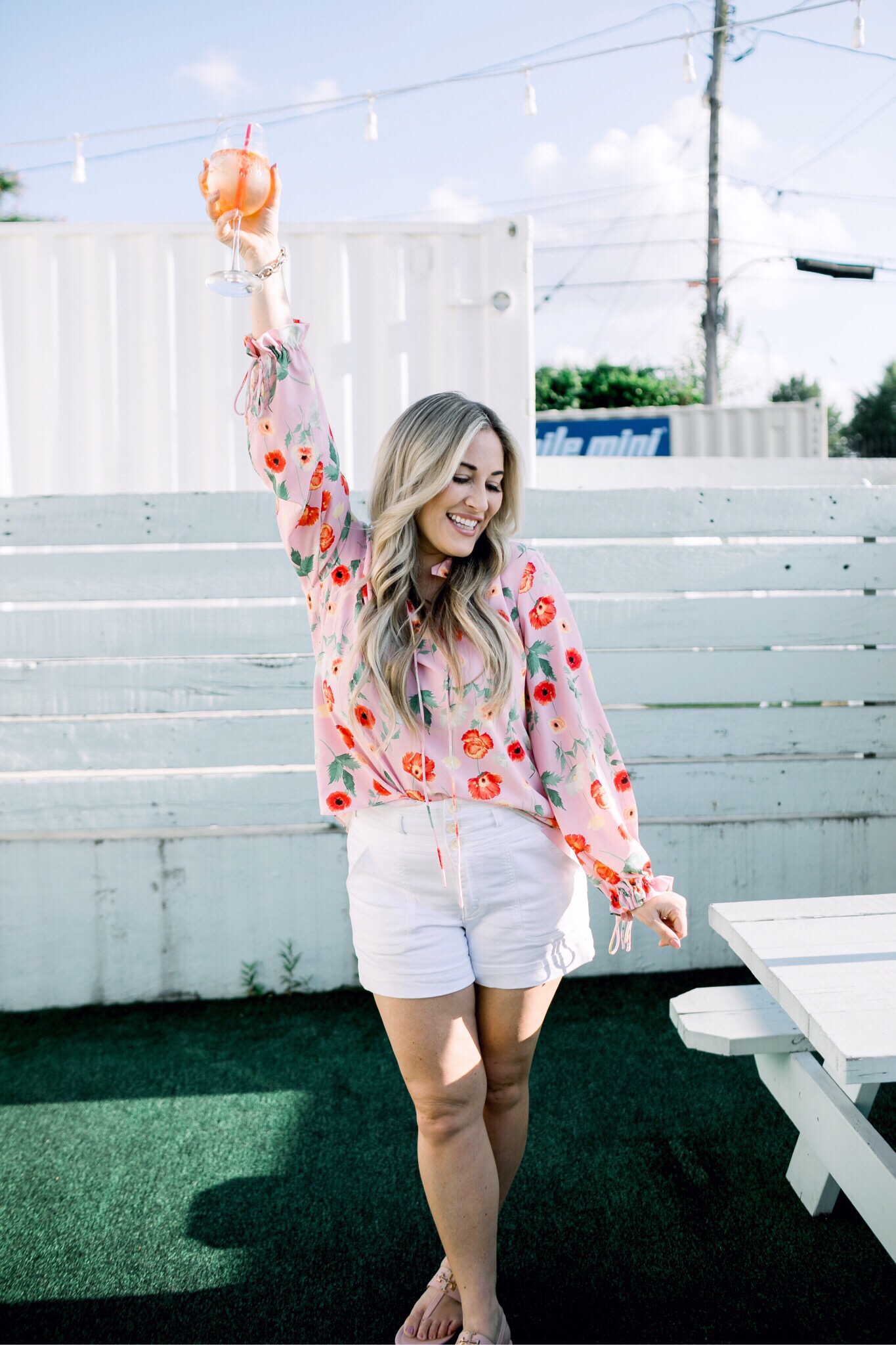 Bright summer colors fashion featured by top US fashion blog, Walking in Memphis in High Heels: image of a woman wearing a Gibson & Latimer floral shirt, Anthropologie high waisted white denim shorts, Tory Burch Miller flip flops and a David Yurman bracelet