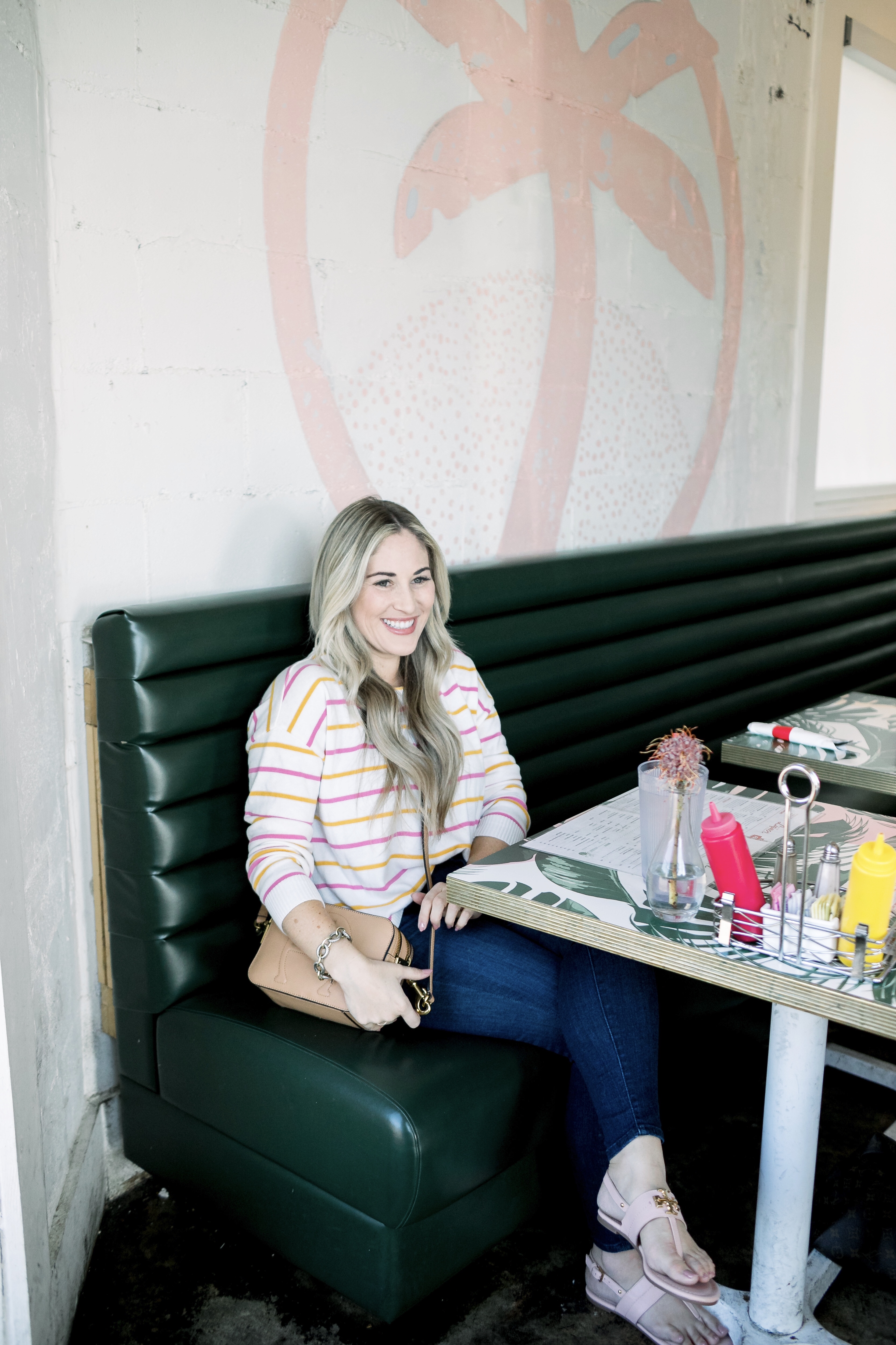 Cute summer to fall casual look styled by top US fashion blog, Walking in Memphis in High Heels: image of a woman wearing a Pink Lily Boutique striped sweater, Good American high waisted skinny jeans, and Tory Burch sandals.