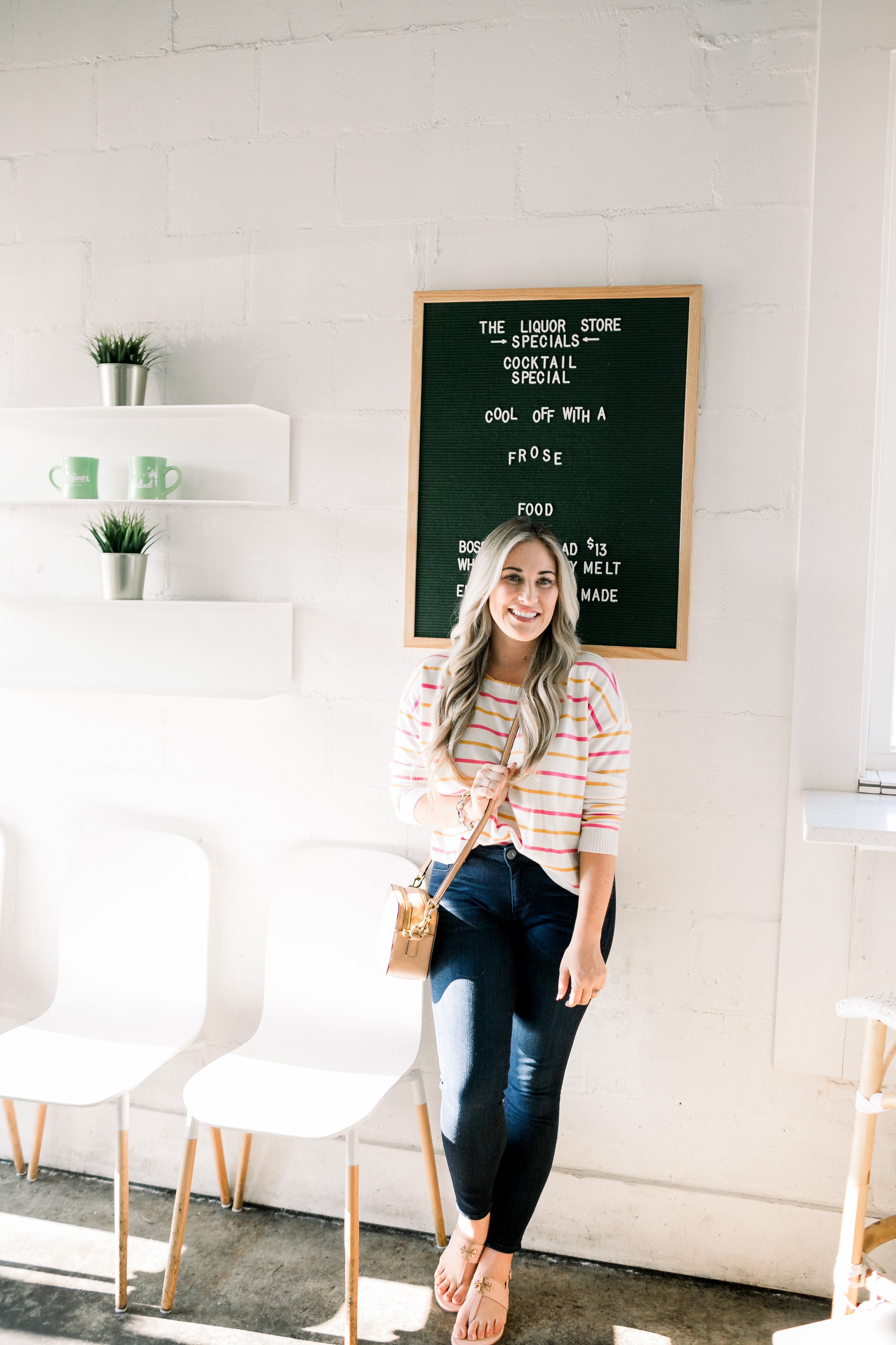 Cute summer to fall casual look styled by top US fashion blog, Walking in Memphis in High Heels: image of a woman wearing a Pink Lily Boutique striped sweater, Good American high waisted skinny jeans, and Tory Burch sandals.