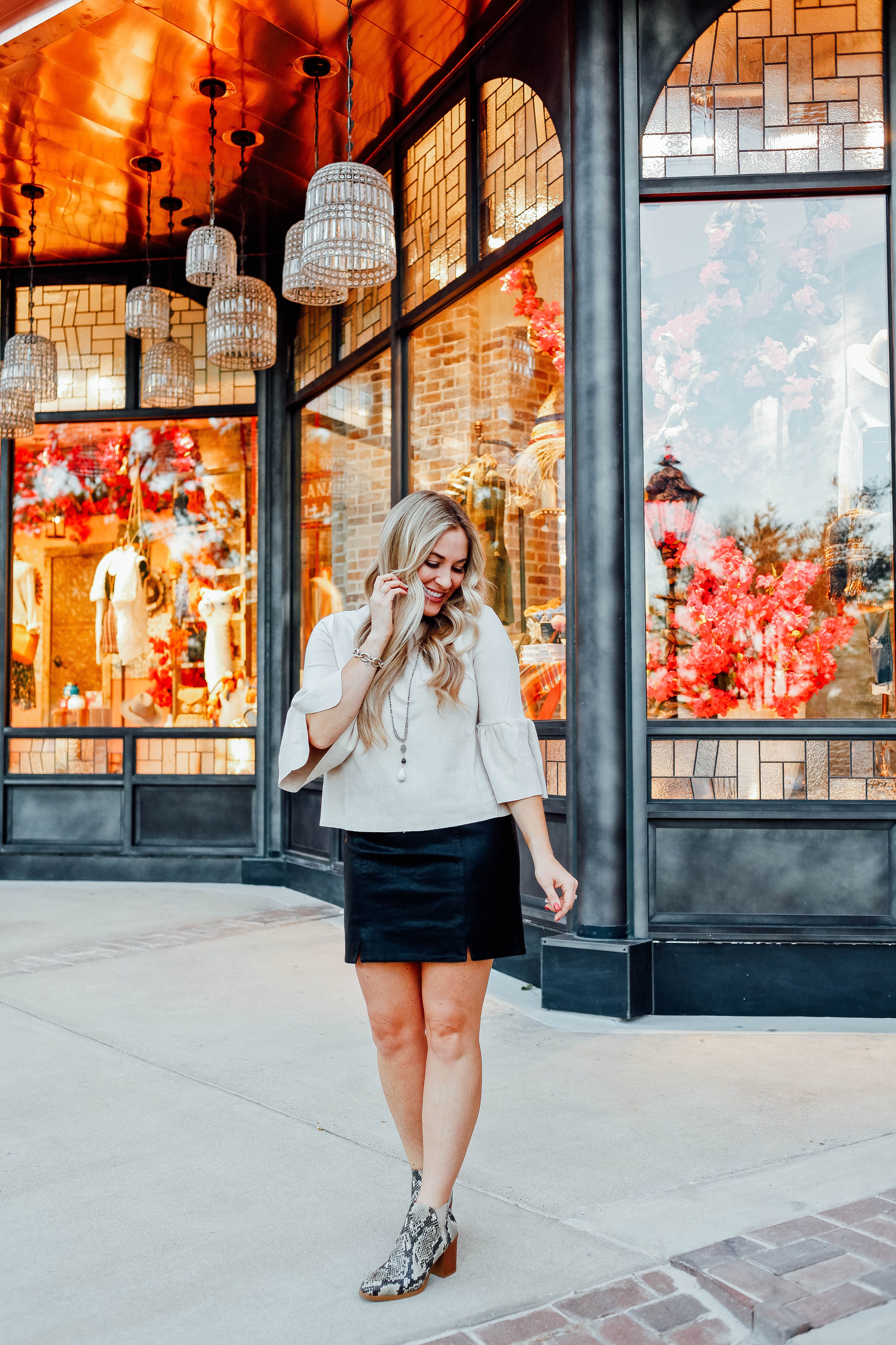 Fall Fashion Essentials featured by top US fashion blog, Walking in Memphis in High Heels: image of a woman wearing snakeskin leather booties, faux leather mini skirt, suede bell sleeve top from Altar'd Sata.